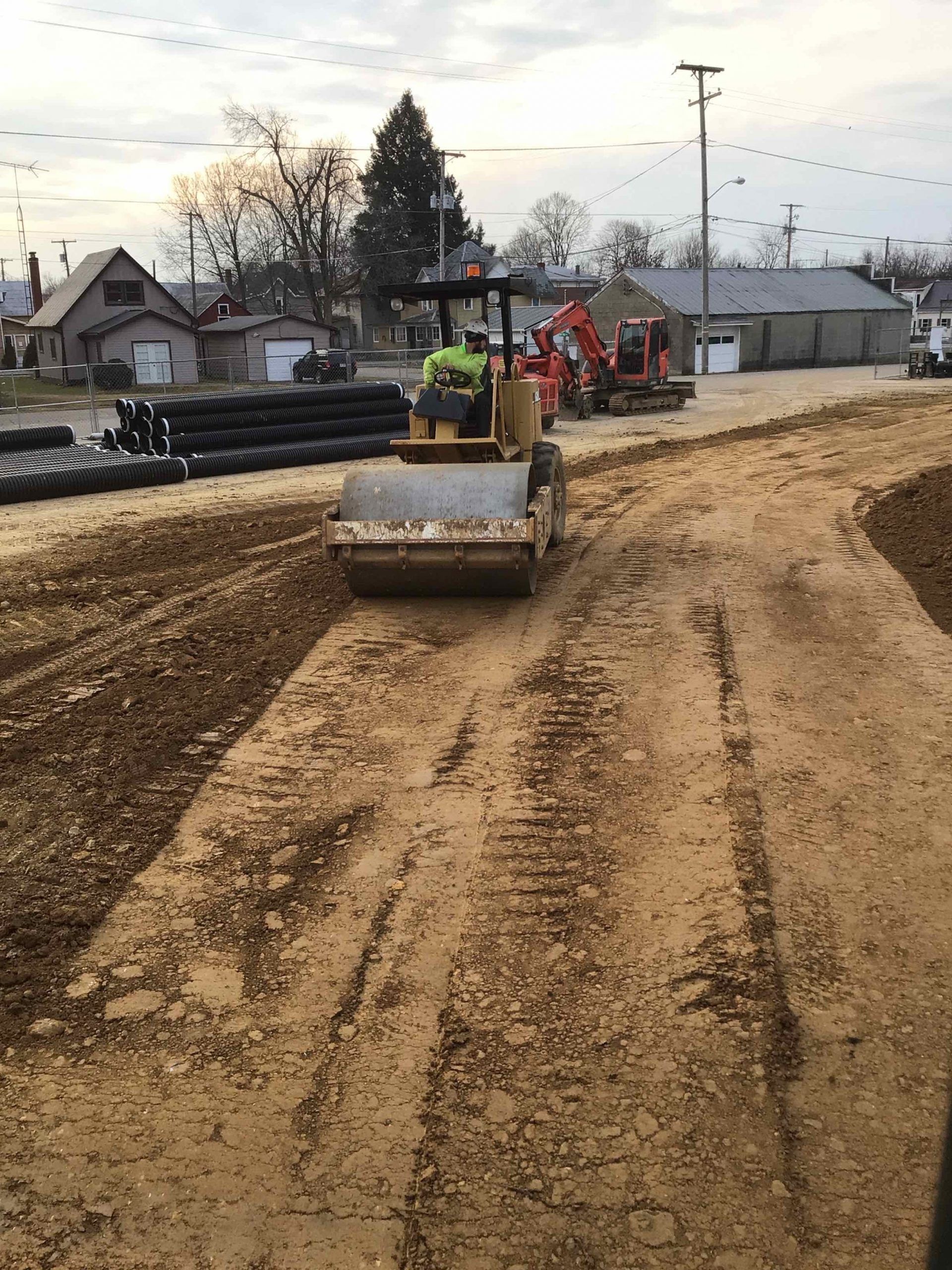 A bulldozer is driving down a dirt road.
