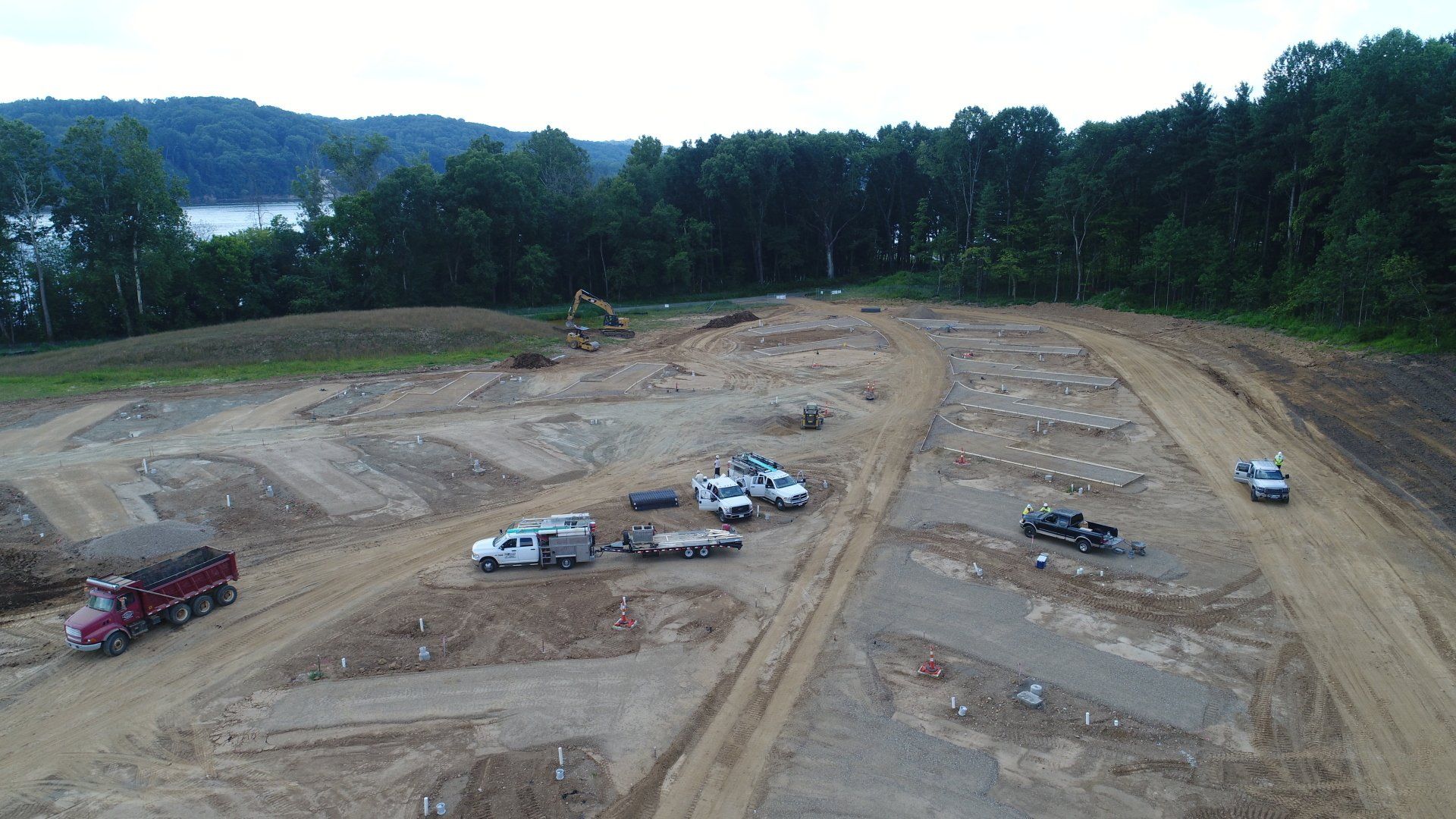 An aerial view of a construction site with trucks and tractors
