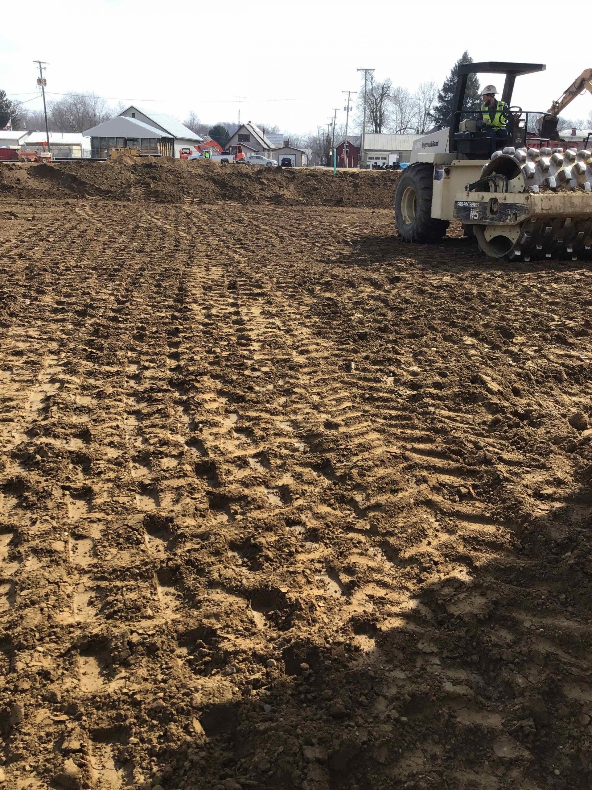 A bulldozer is plowing a dirt field.