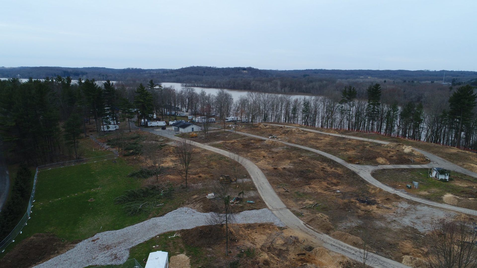 An aerial view of a residential area with a river in the background.