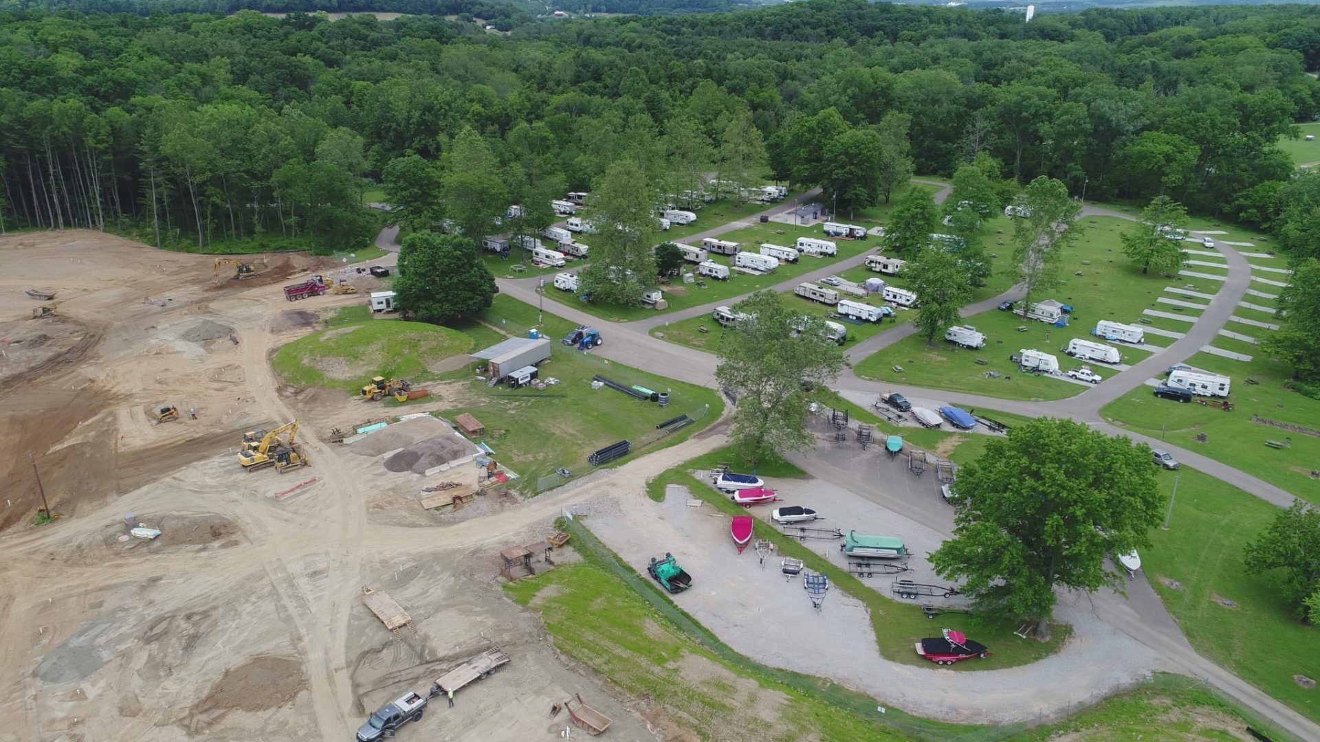 An aerial view of a campground filled with lots of cars and trucks.