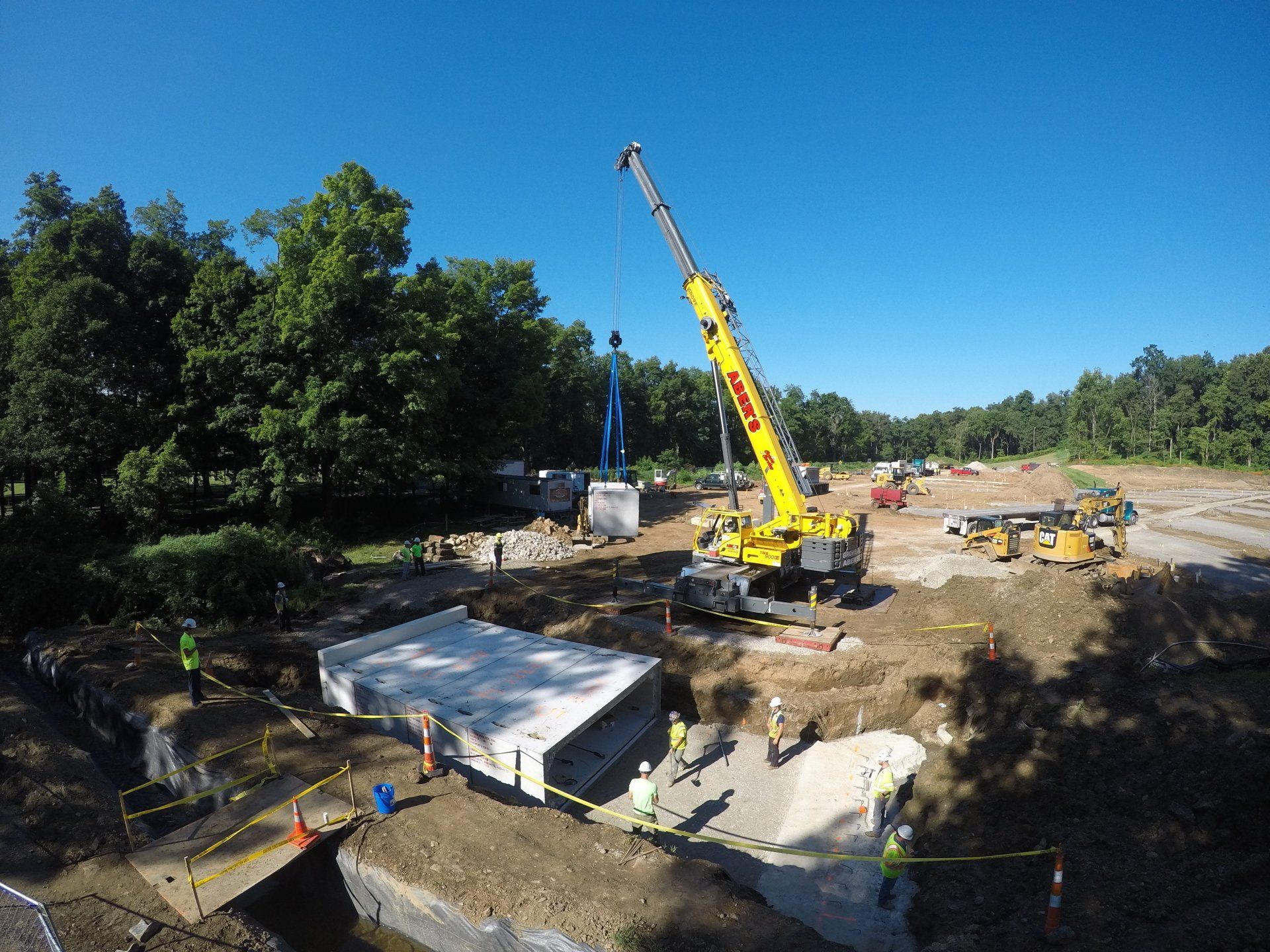 An aerial view of a construction site with a large yellow crane.