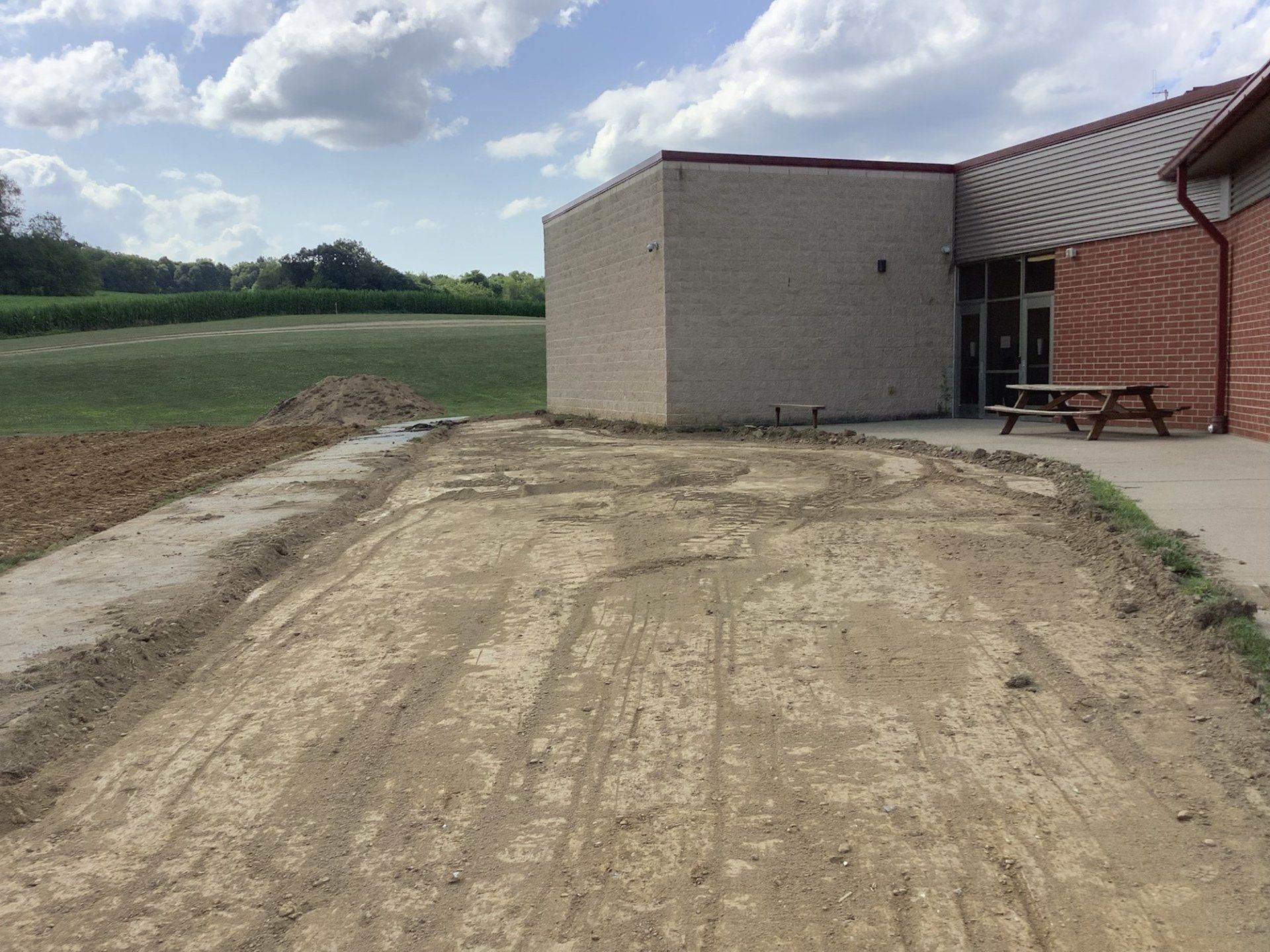 A brick building with a picnic table in front of it