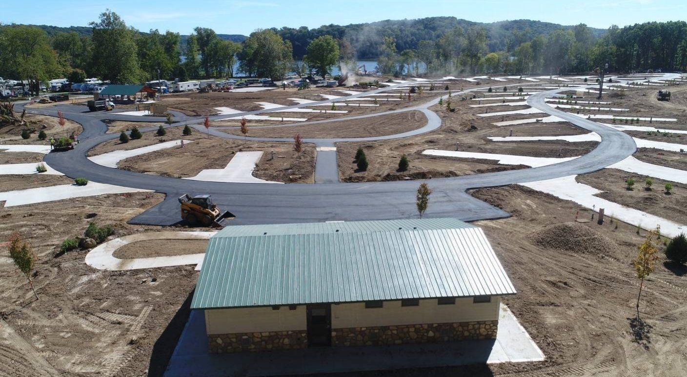 An aerial view of a campground with a small house in the middle