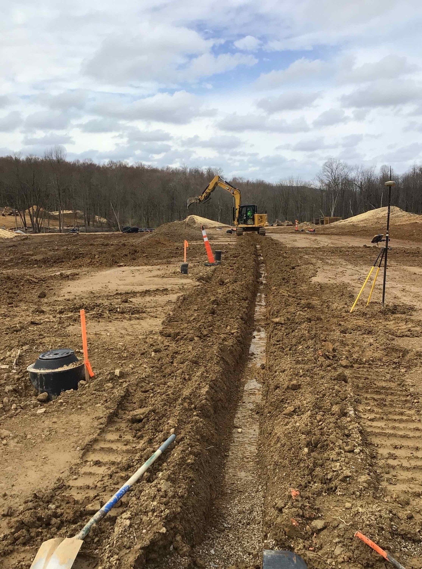 A construction site with a bulldozer and shovels in the dirt.