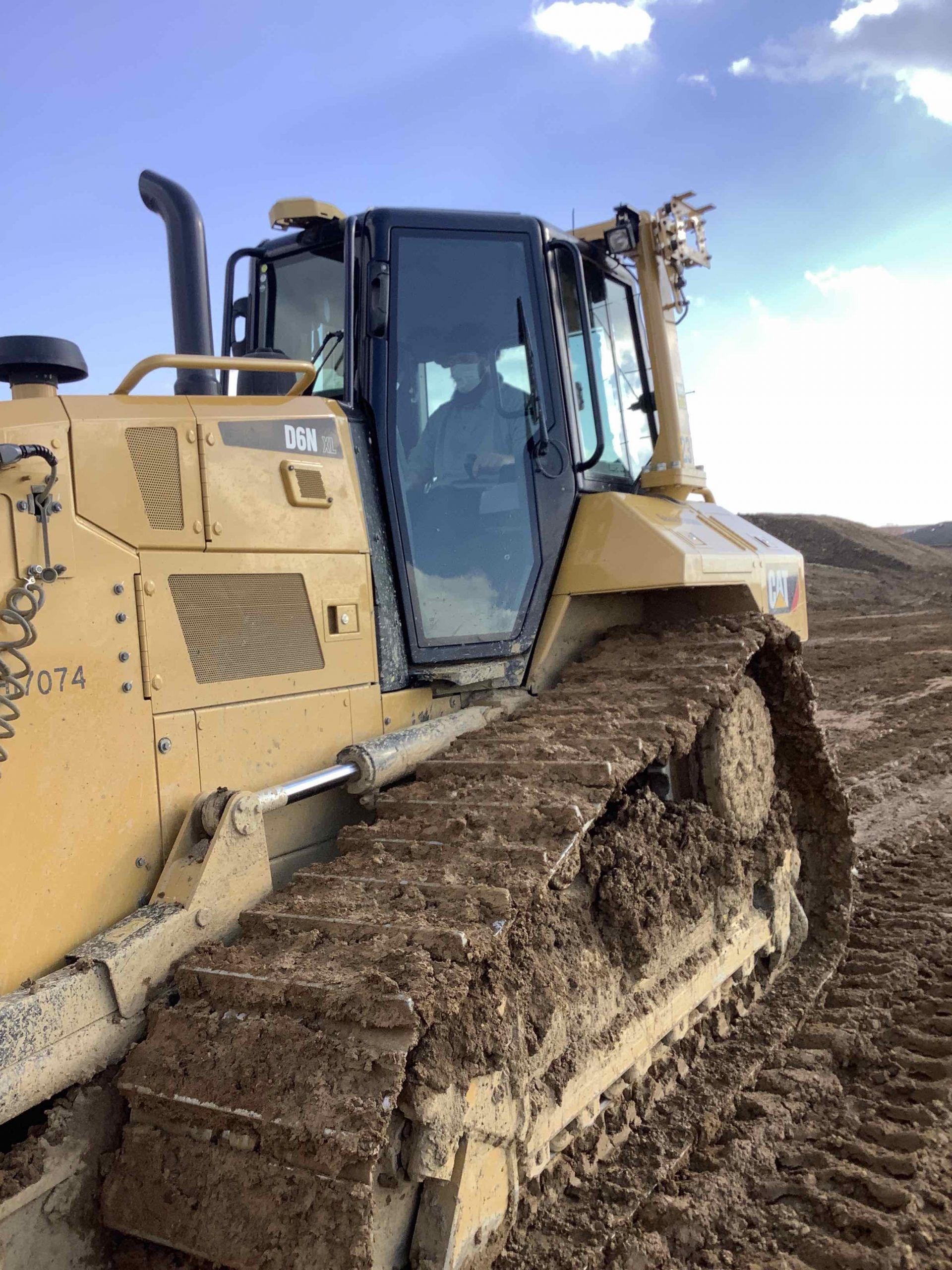 A bulldozer is sitting on top of a dirt field.