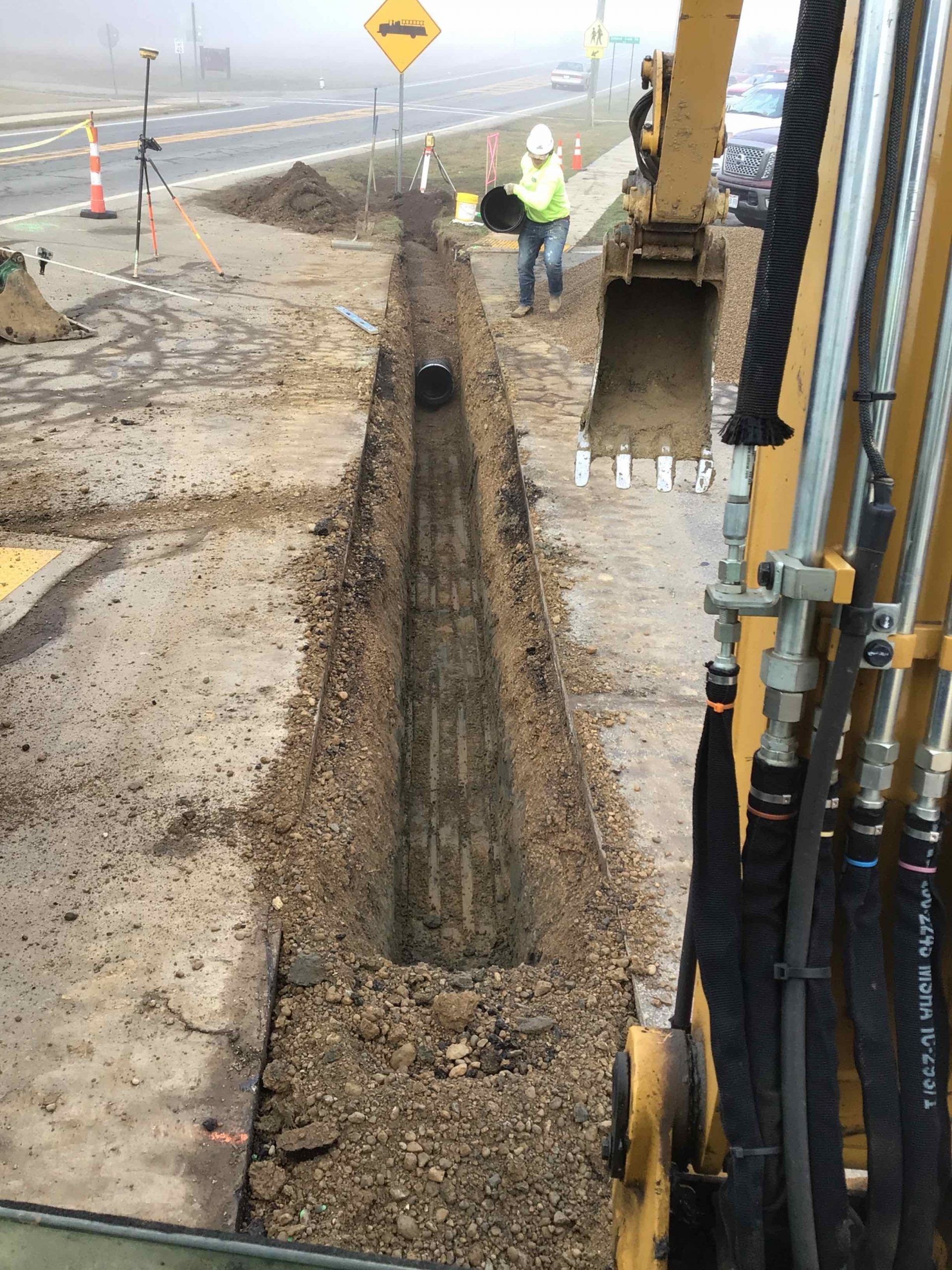 A man is digging a hole in the ground with a bulldozer.