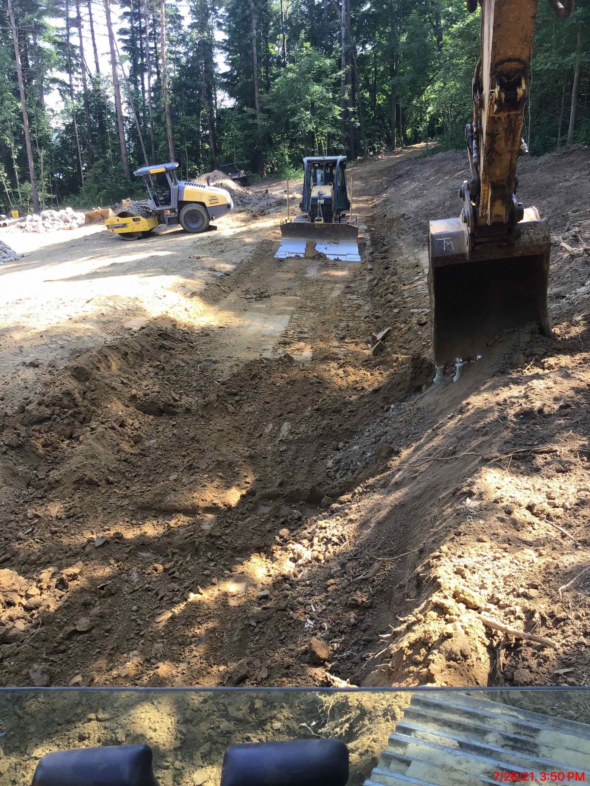 A bulldozer is digging a hole in the dirt on a construction site.