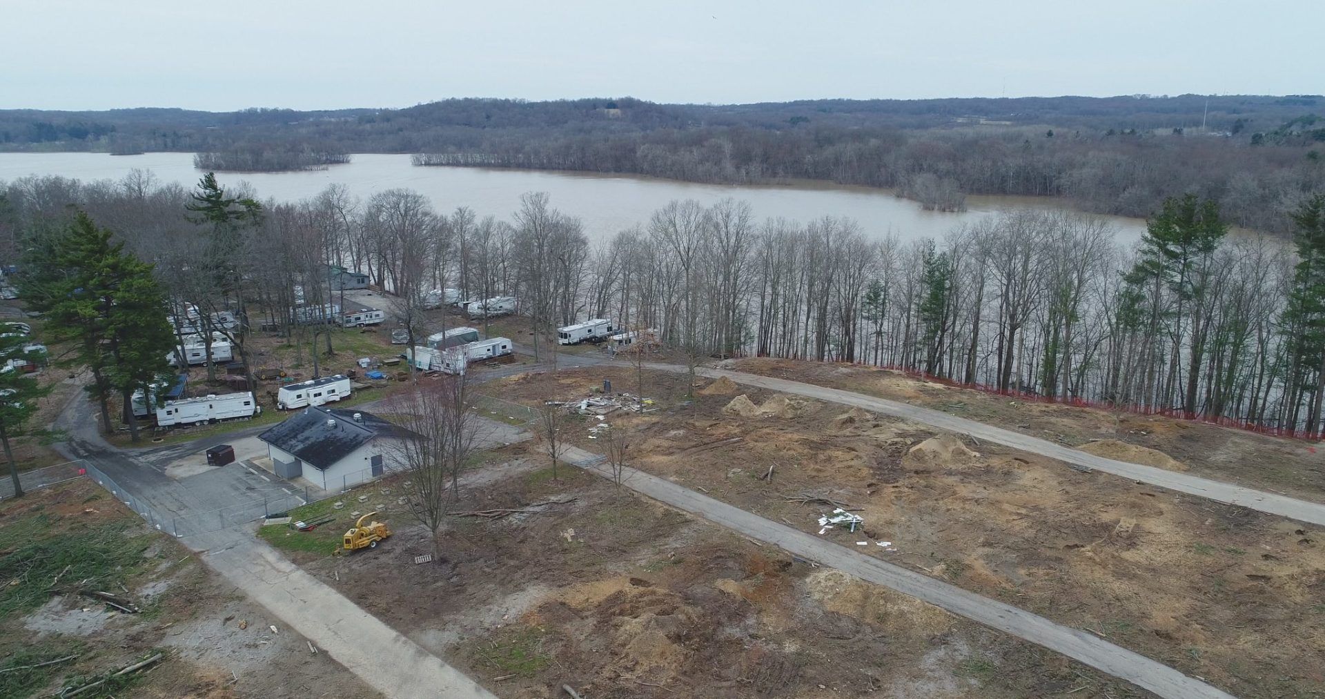 An aerial view of a residential area with a lake in the background.