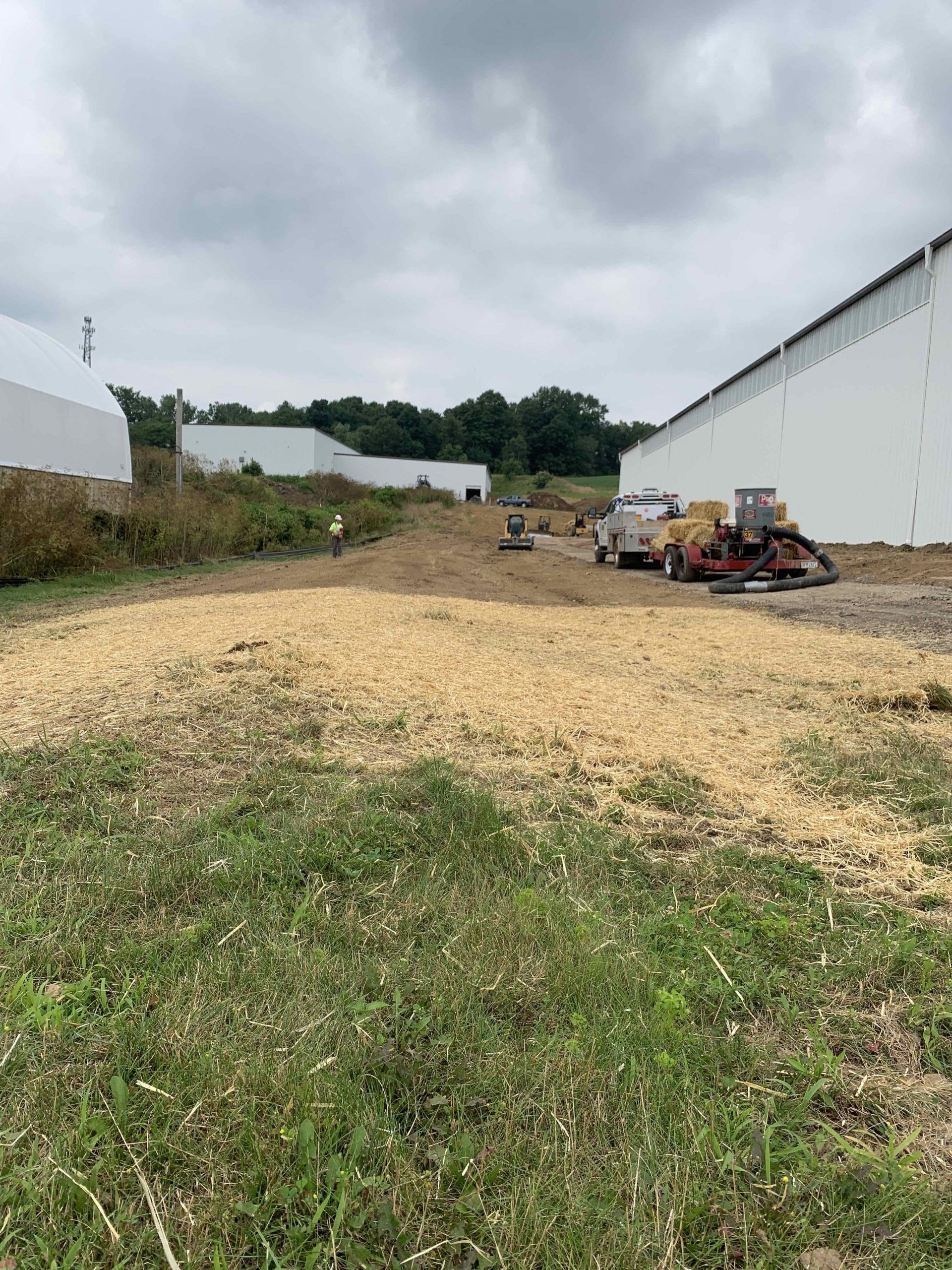 A large white building with a lot of grass in front of it.