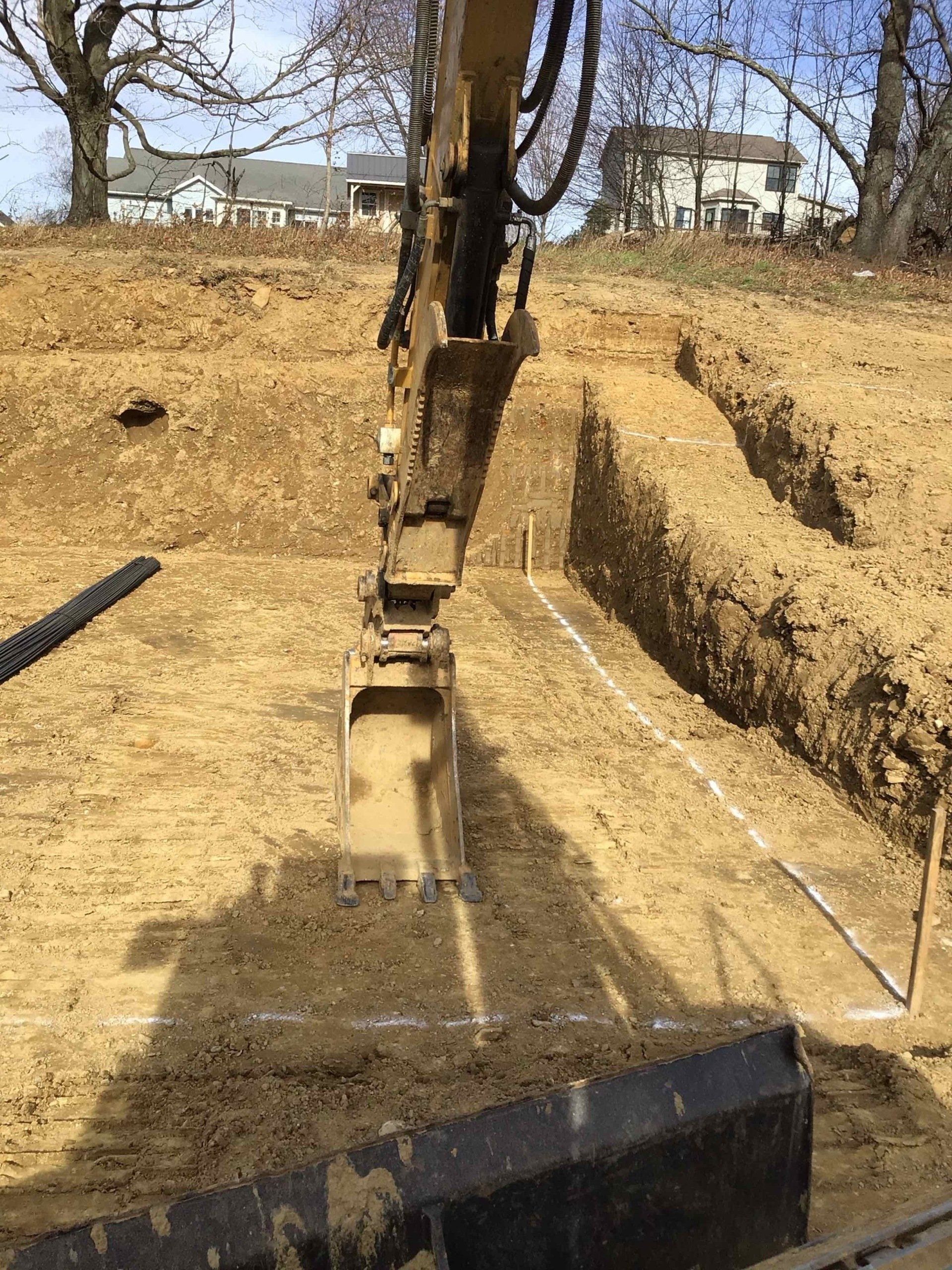A bulldozer is digging a hole in the dirt.