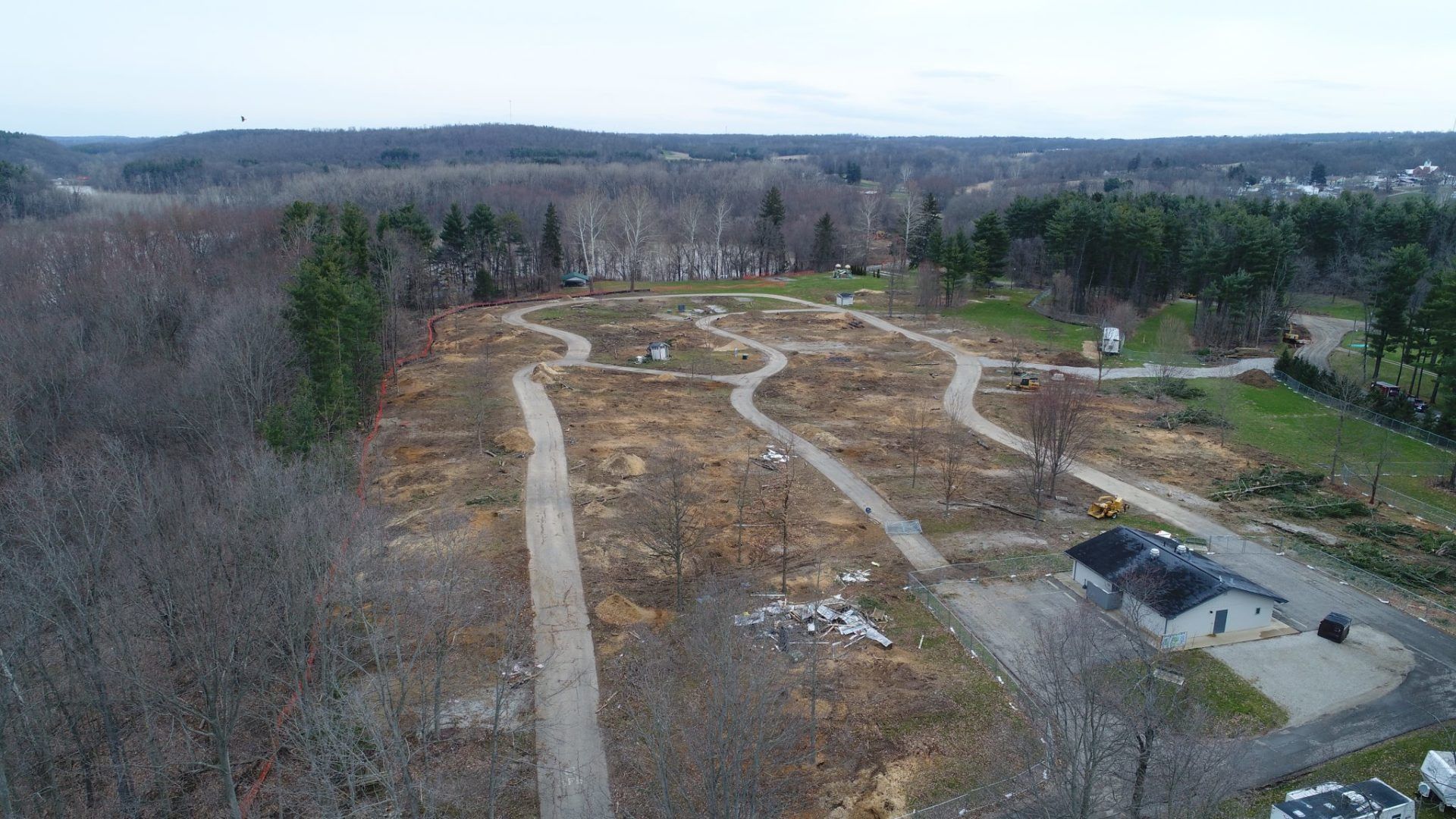 An aerial view of a park with a lot of trees and paths.