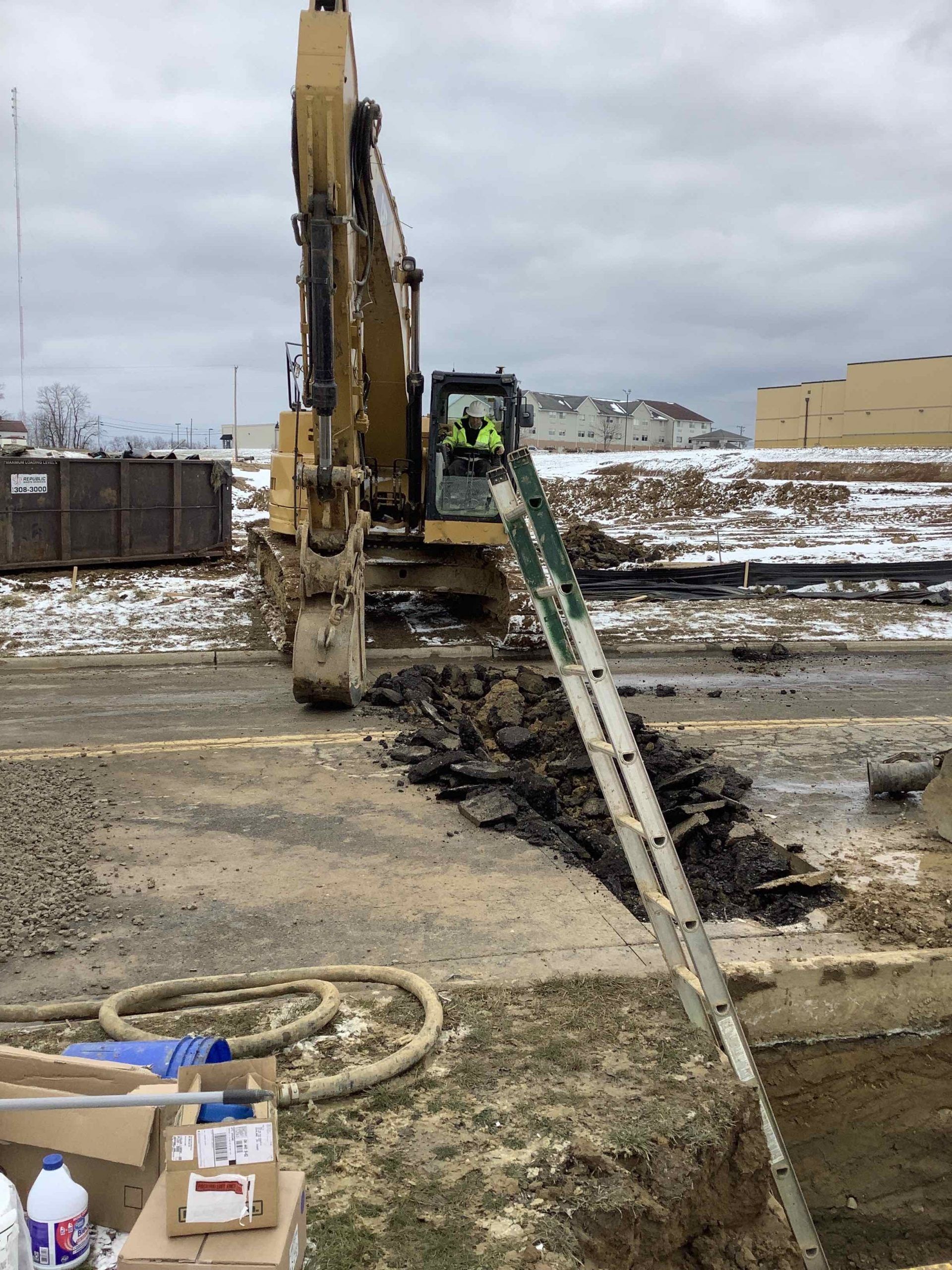A man is driving a bulldozer on a construction site
