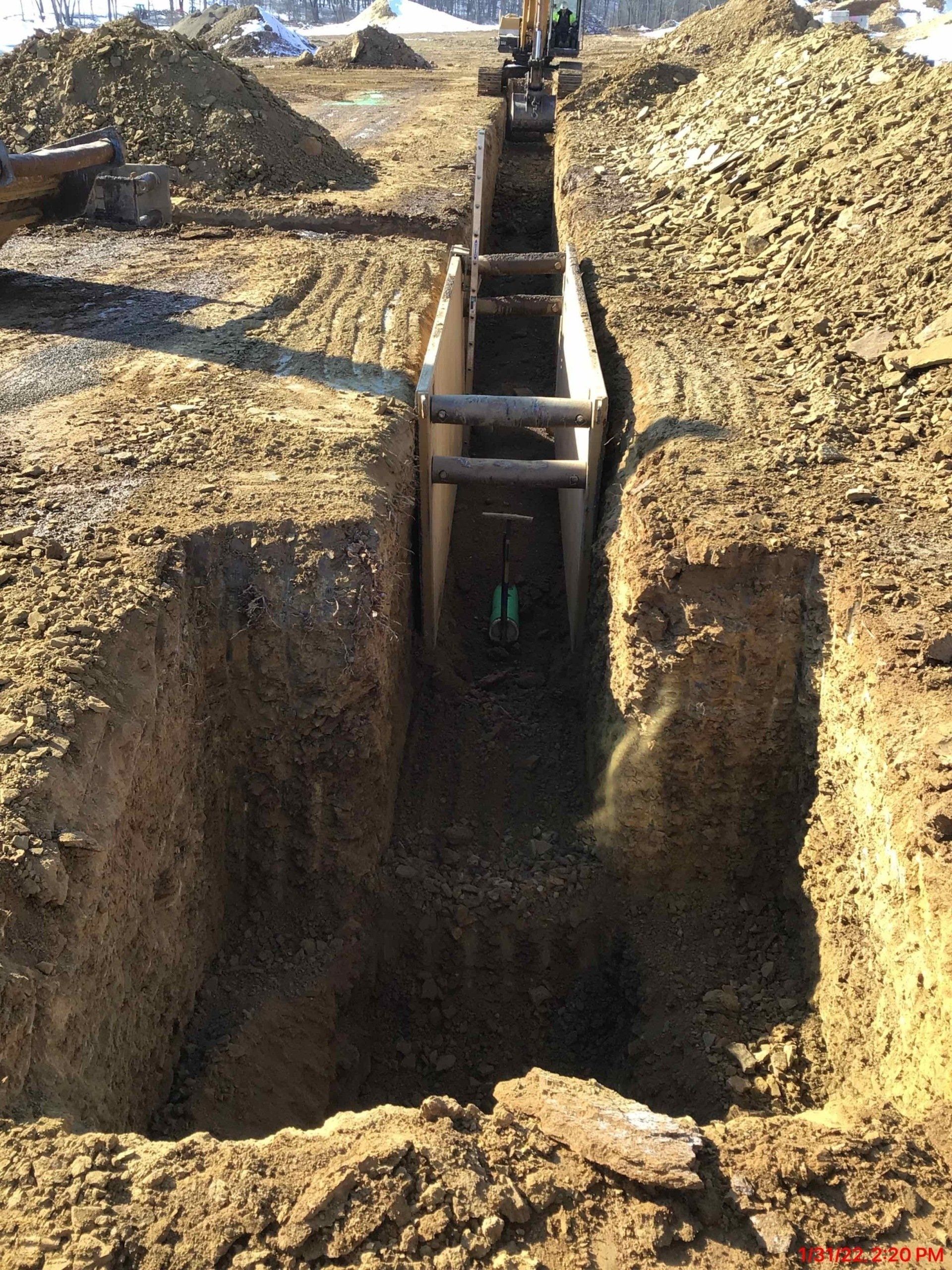 A large hole in the ground with a wooden structure in it.