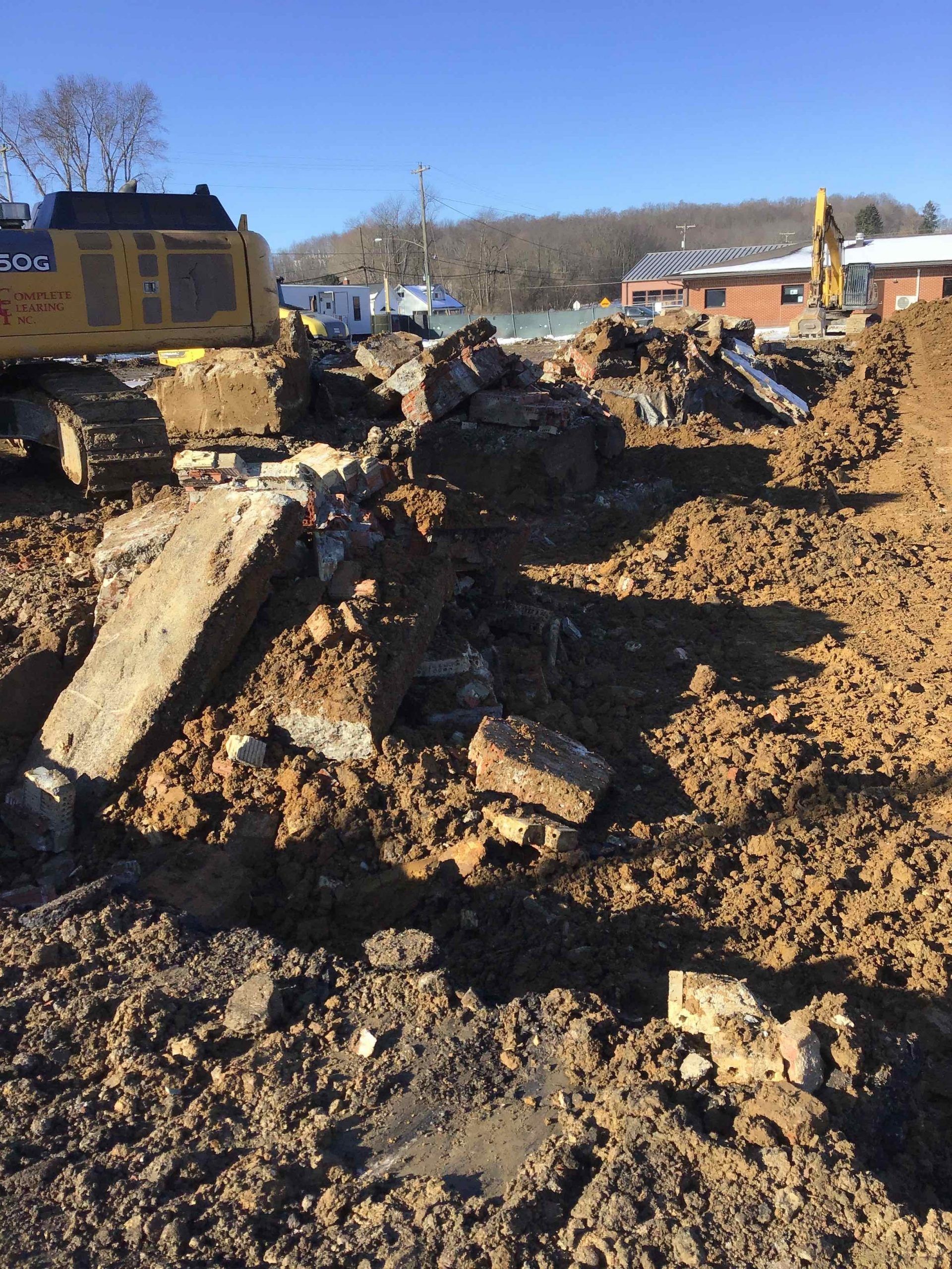 A construction site with a large pile of dirt and a bulldozer.