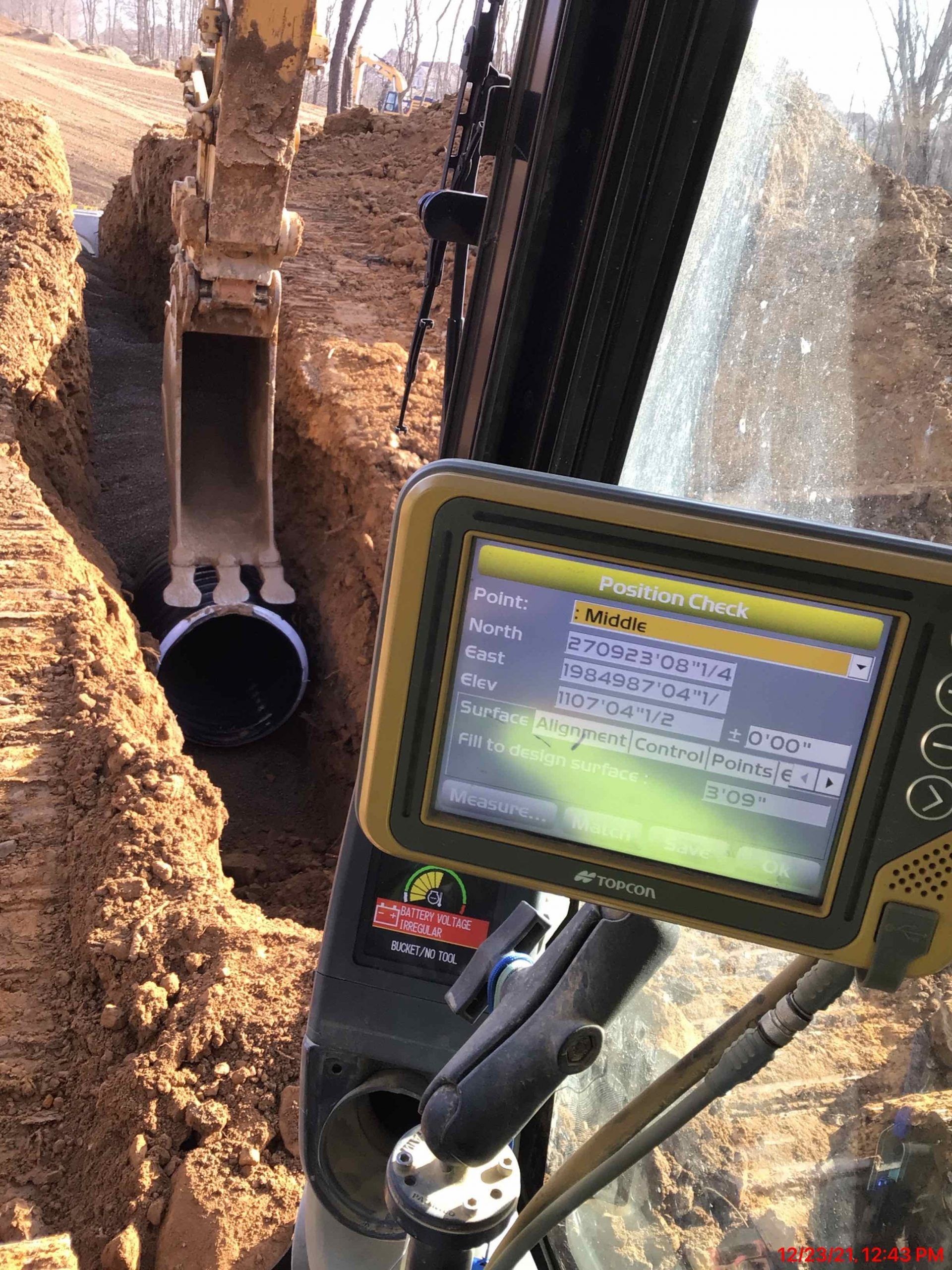 A tablet is sitting on the dashboard of a construction vehicle.