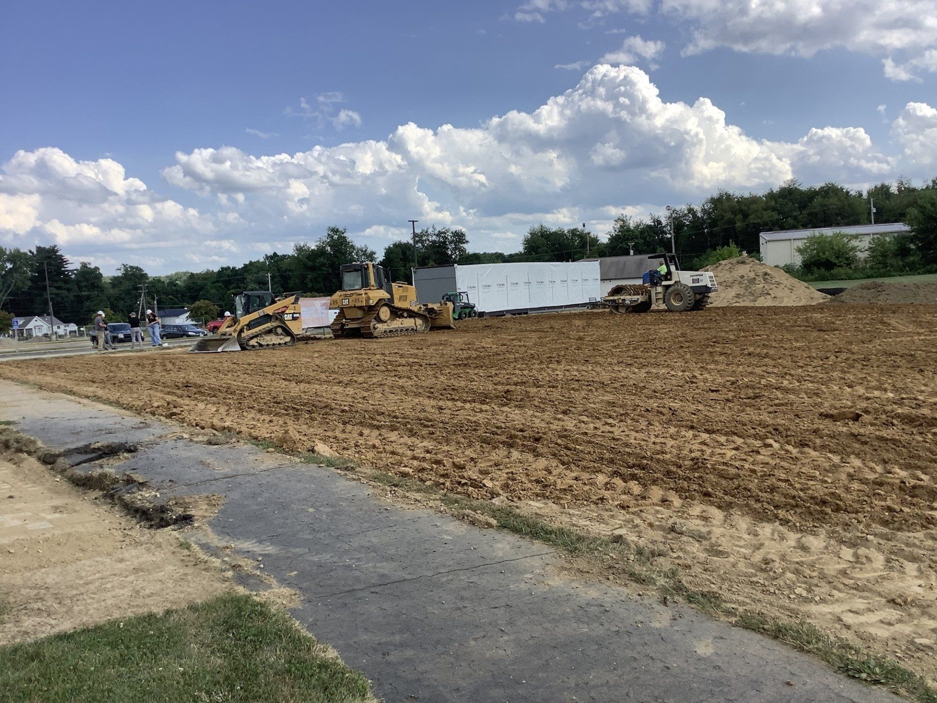 A large dirt field with a lot of machinery in it.