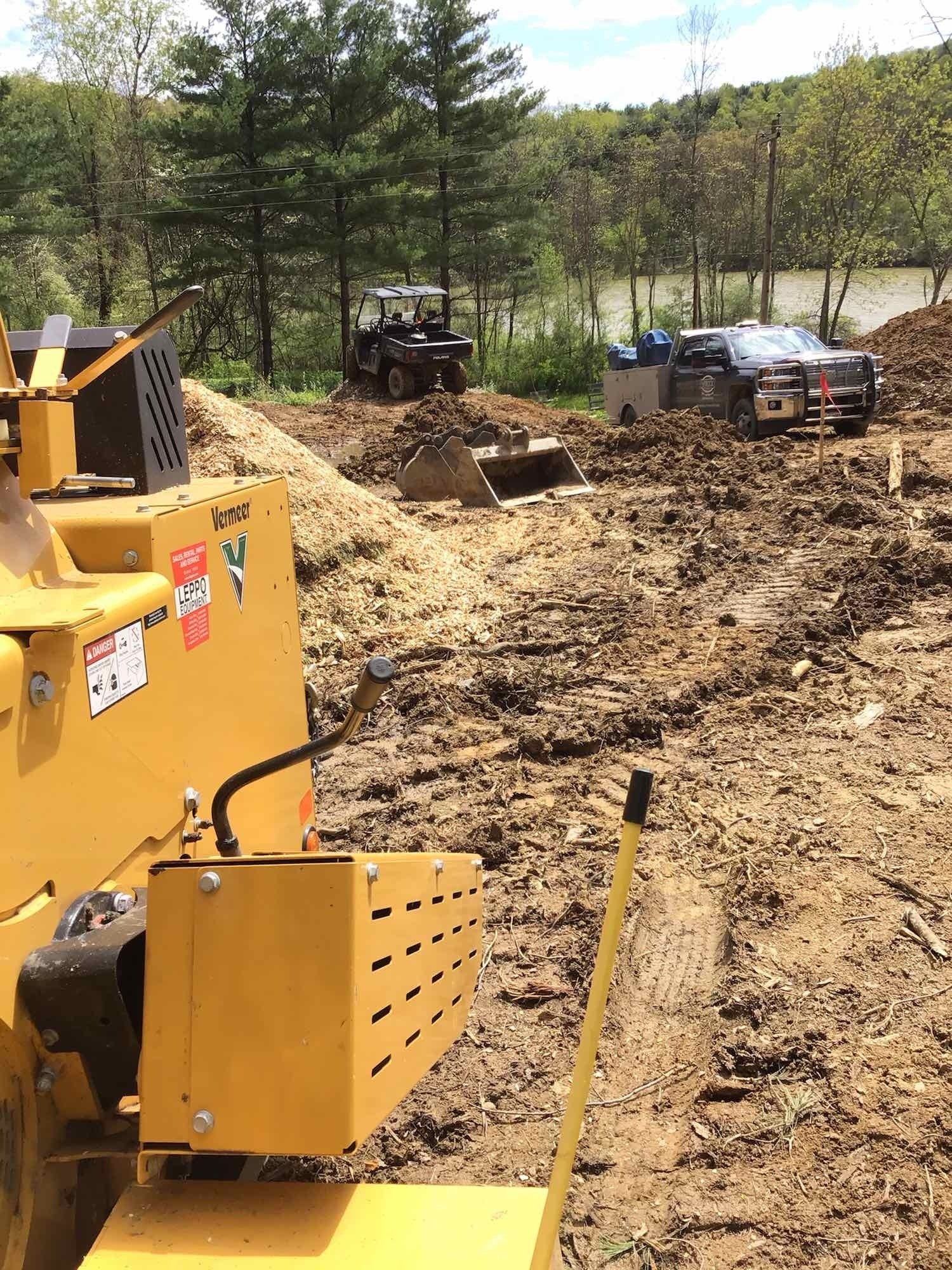 A bulldozer is sitting in the middle of a dirt field.