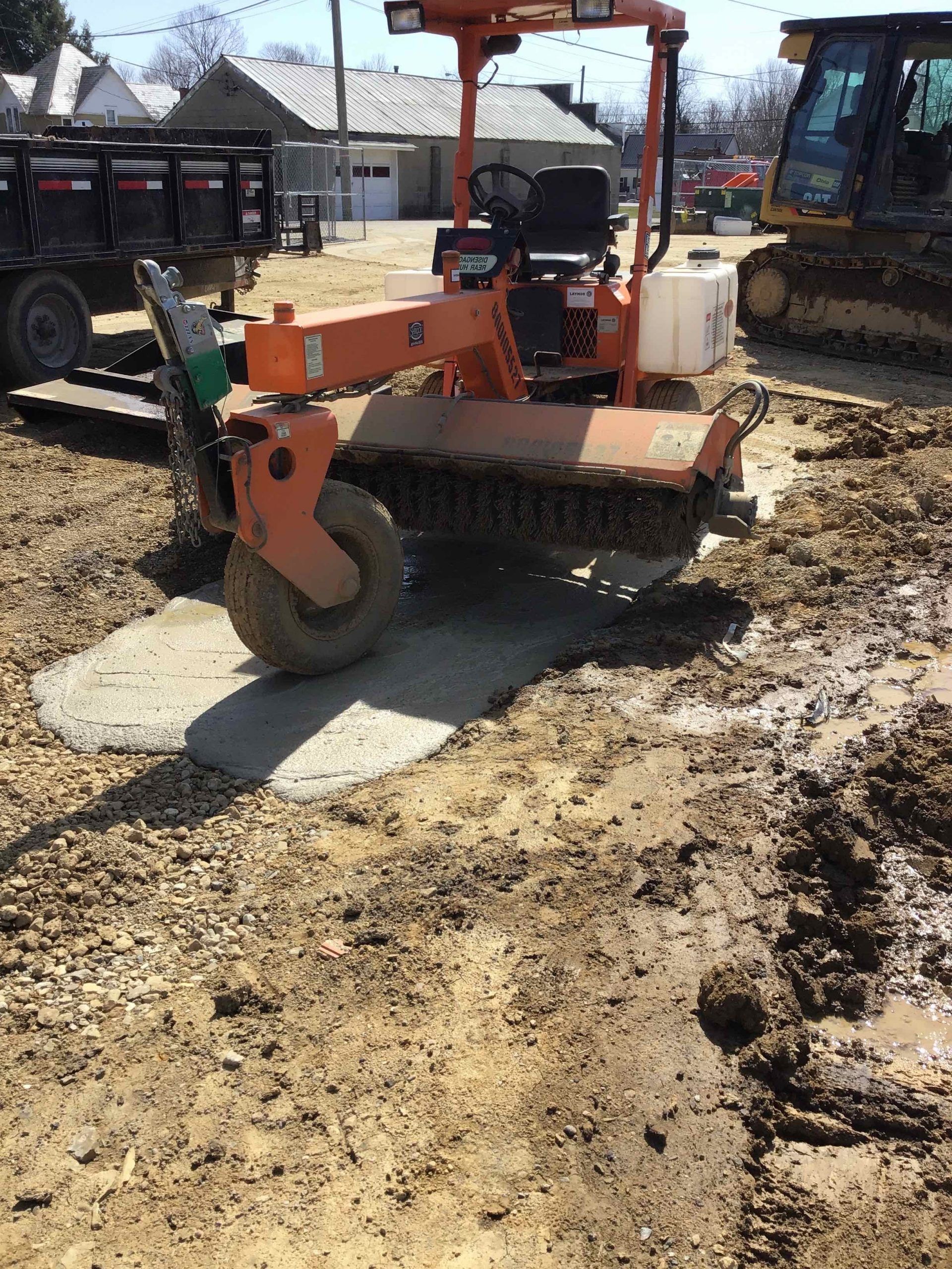 A tractor is sitting in the middle of a muddy field.