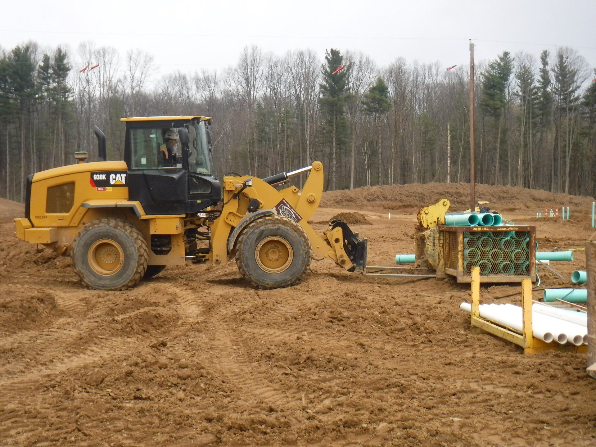 A cat wheel loader is moving dirt on a construction site