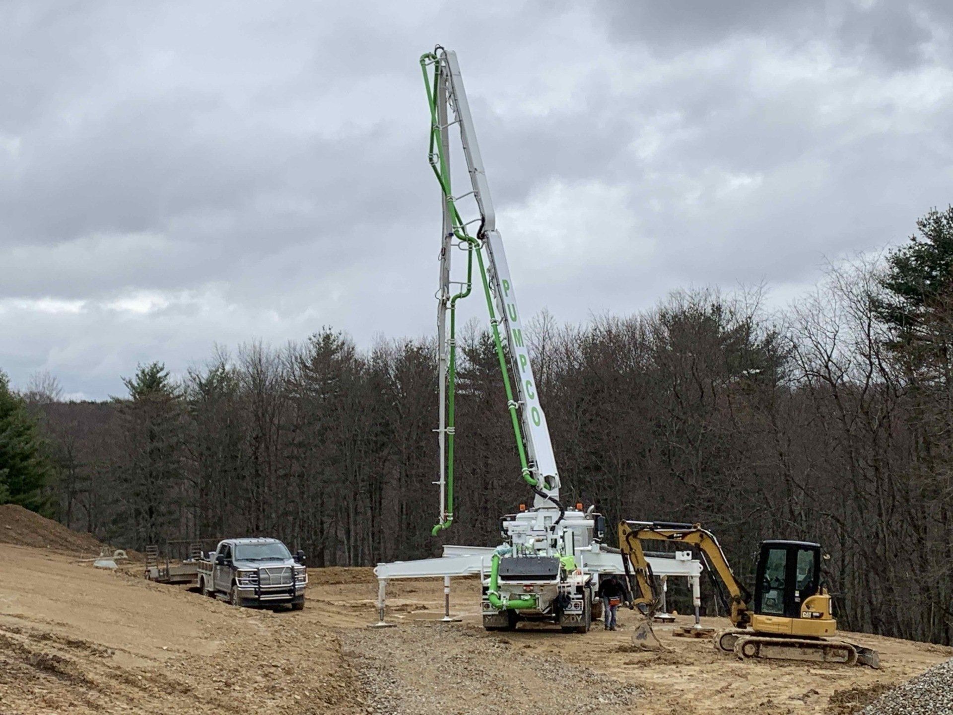 A concrete pump is being used to pump concrete on a construction site.