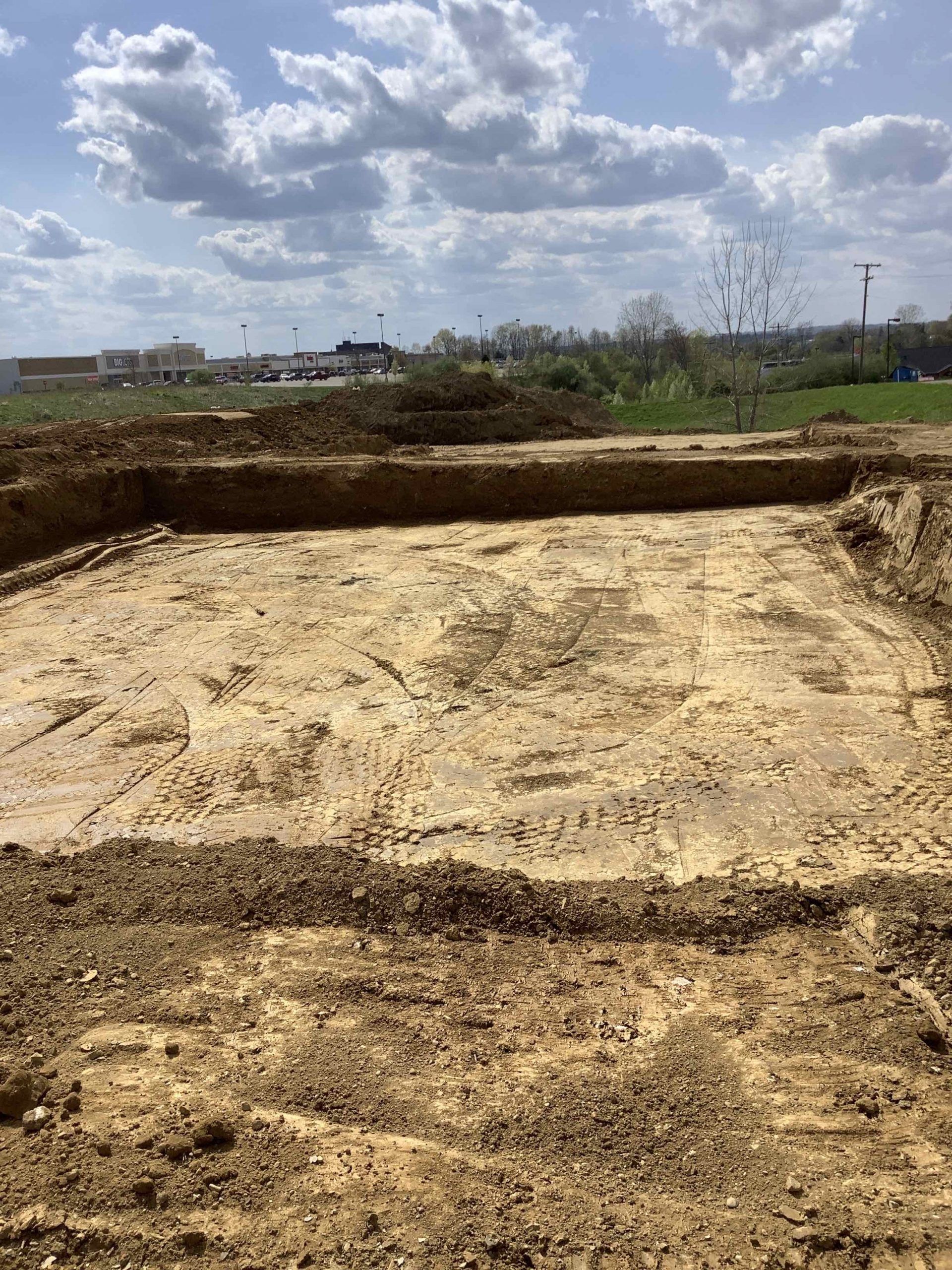 A large pile of dirt is sitting on top of a dirt field.