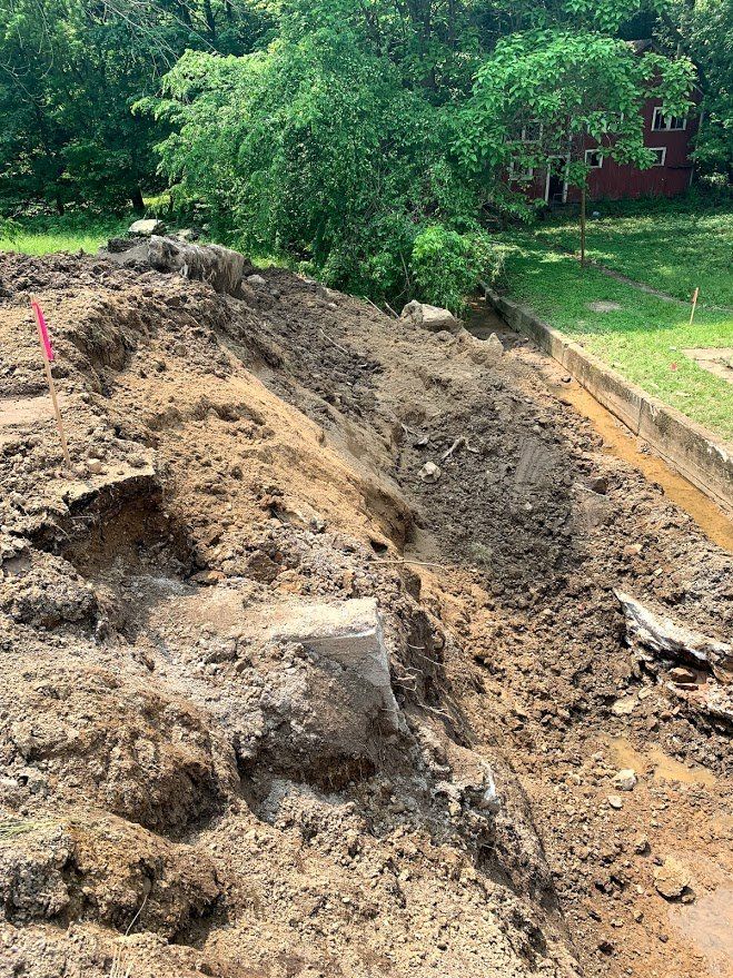 A pile of dirt is sitting on the side of a road.