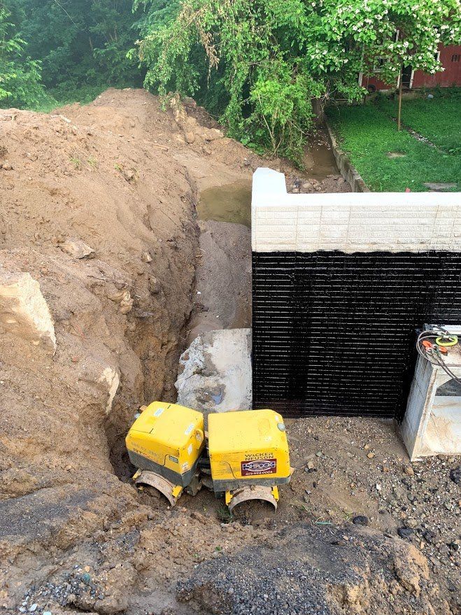 A couple of yellow boxes are sitting on top of a pile of dirt.