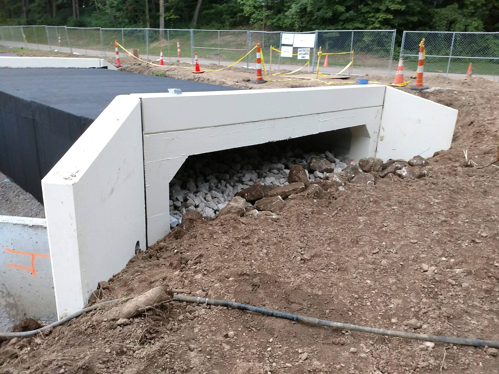A concrete structure is being built in a dirt field.