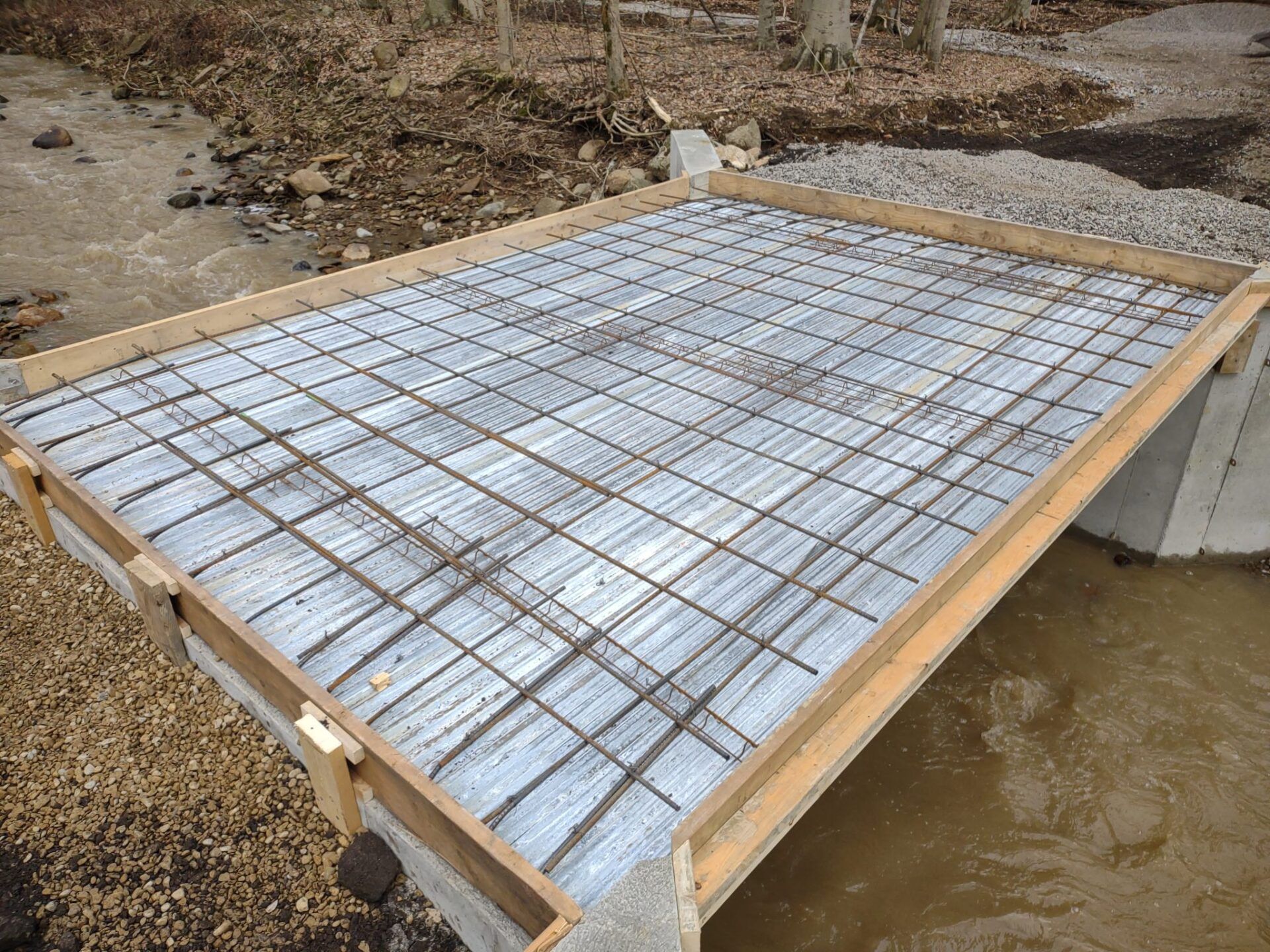 A concrete slab is being built over a body of water
