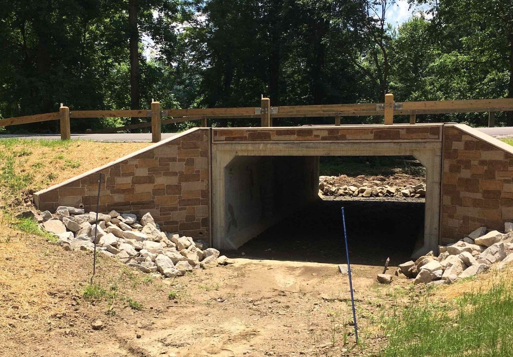 A tunnel with a wooden fence surrounding it