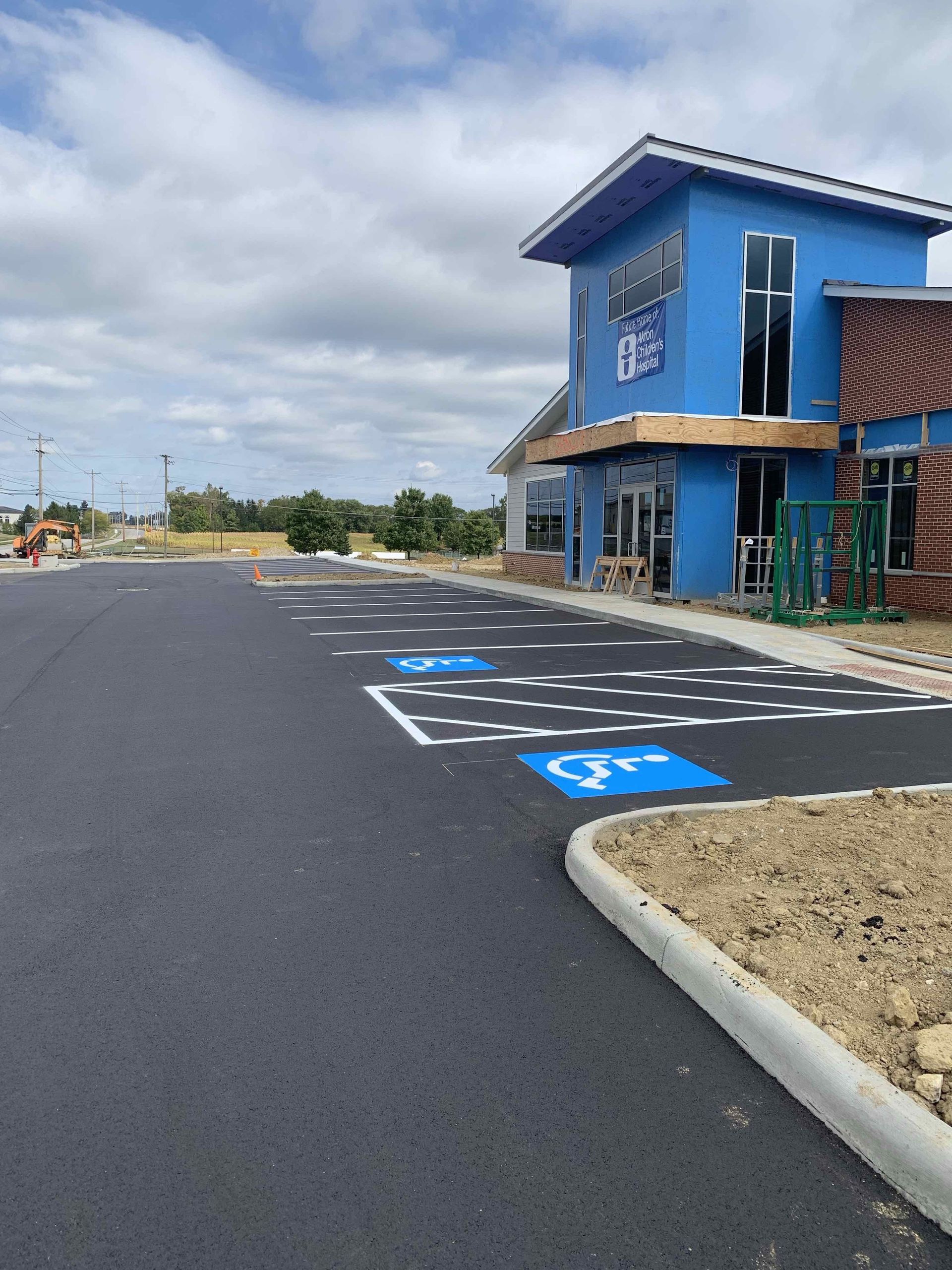 A blue building with a handicapped parking spot in front of it