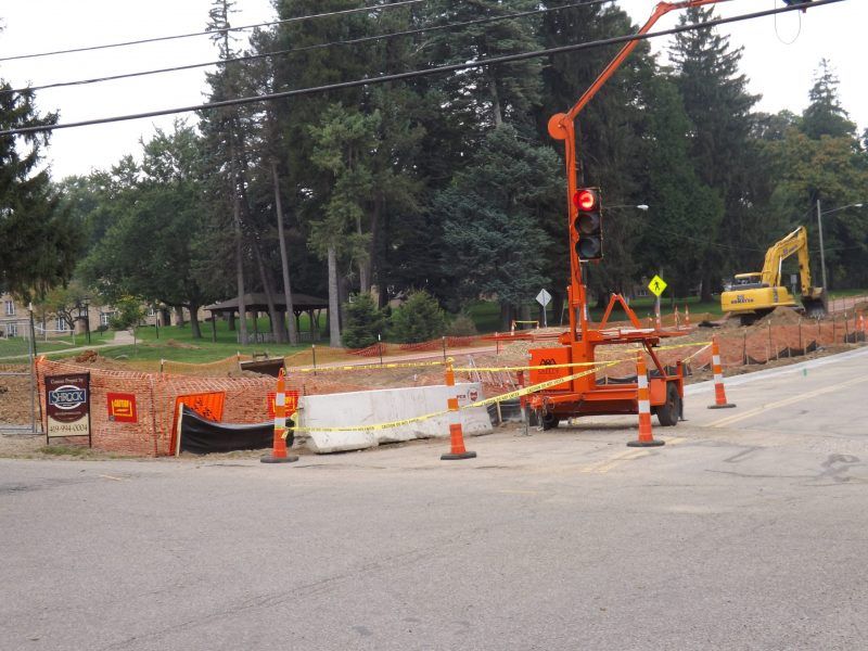 A construction site with a yellow excavator in the background