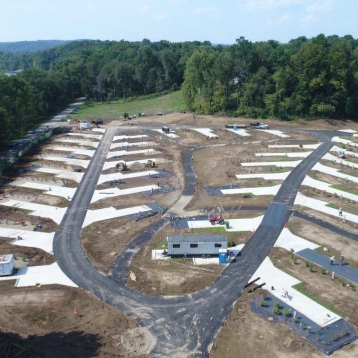 An aerial view of a rv park under construction surrounded by trees.