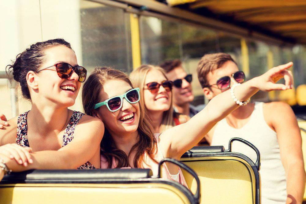 Group of Smiling Friends Travelling by Bus — Coaches in Coffs Harbour, NSW