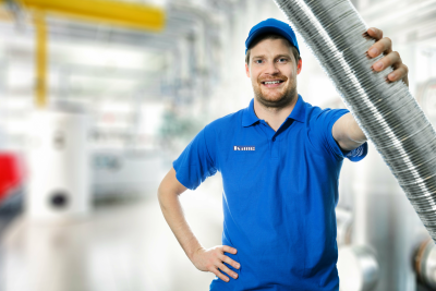 A man in a blue shirt is holding a metal pipe.