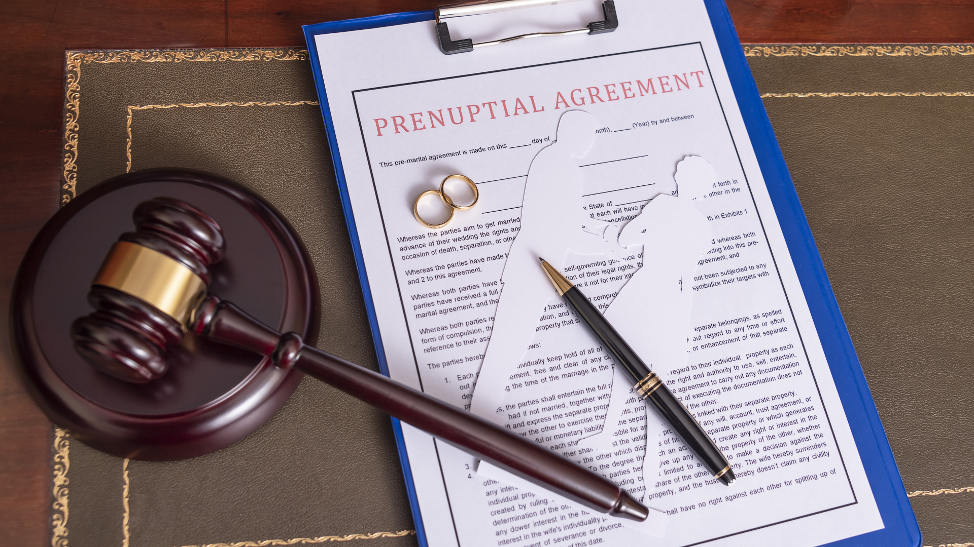 Gavel, agreement document, and pen on a desk, suggesting a legal contract review