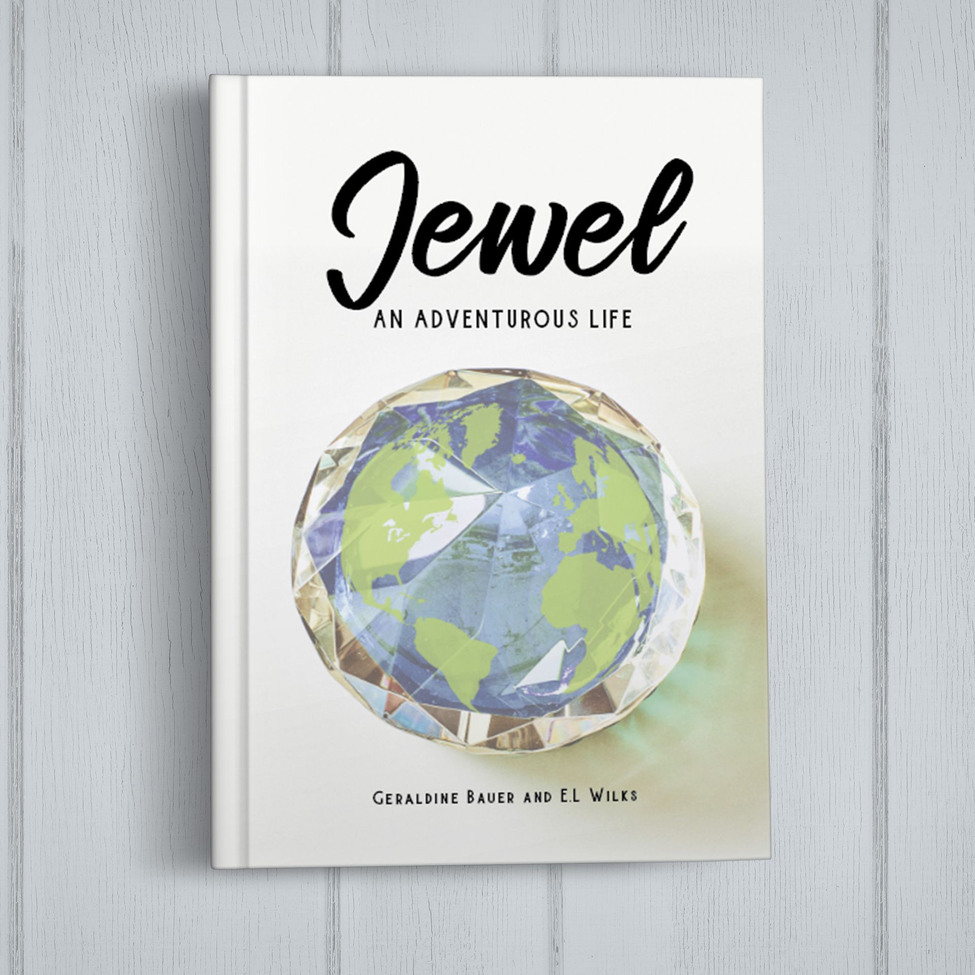 A book called jewel an adventurous life is sitting on a wooden table.