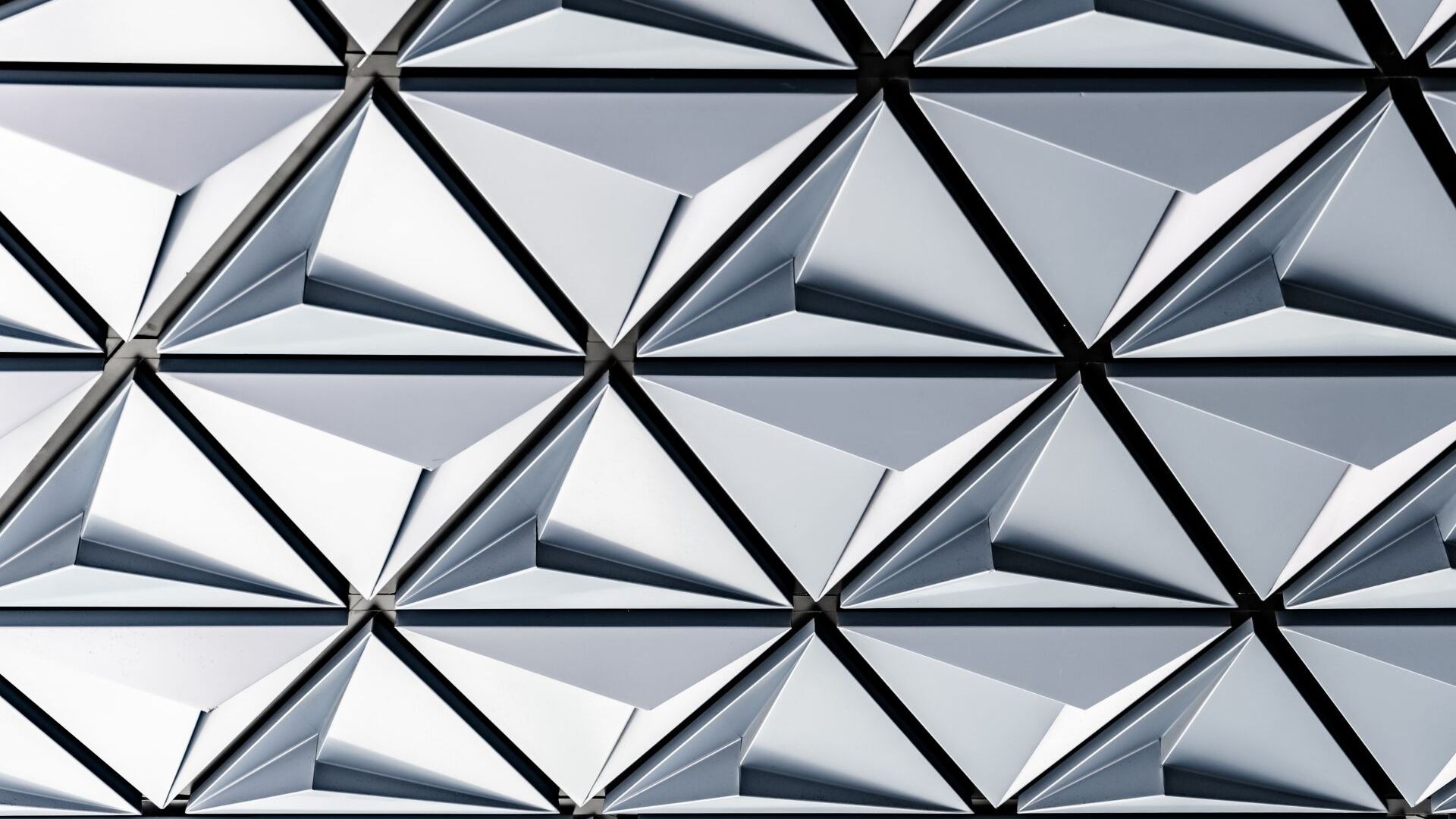 A close up of a geometric pattern of triangles on a wall.