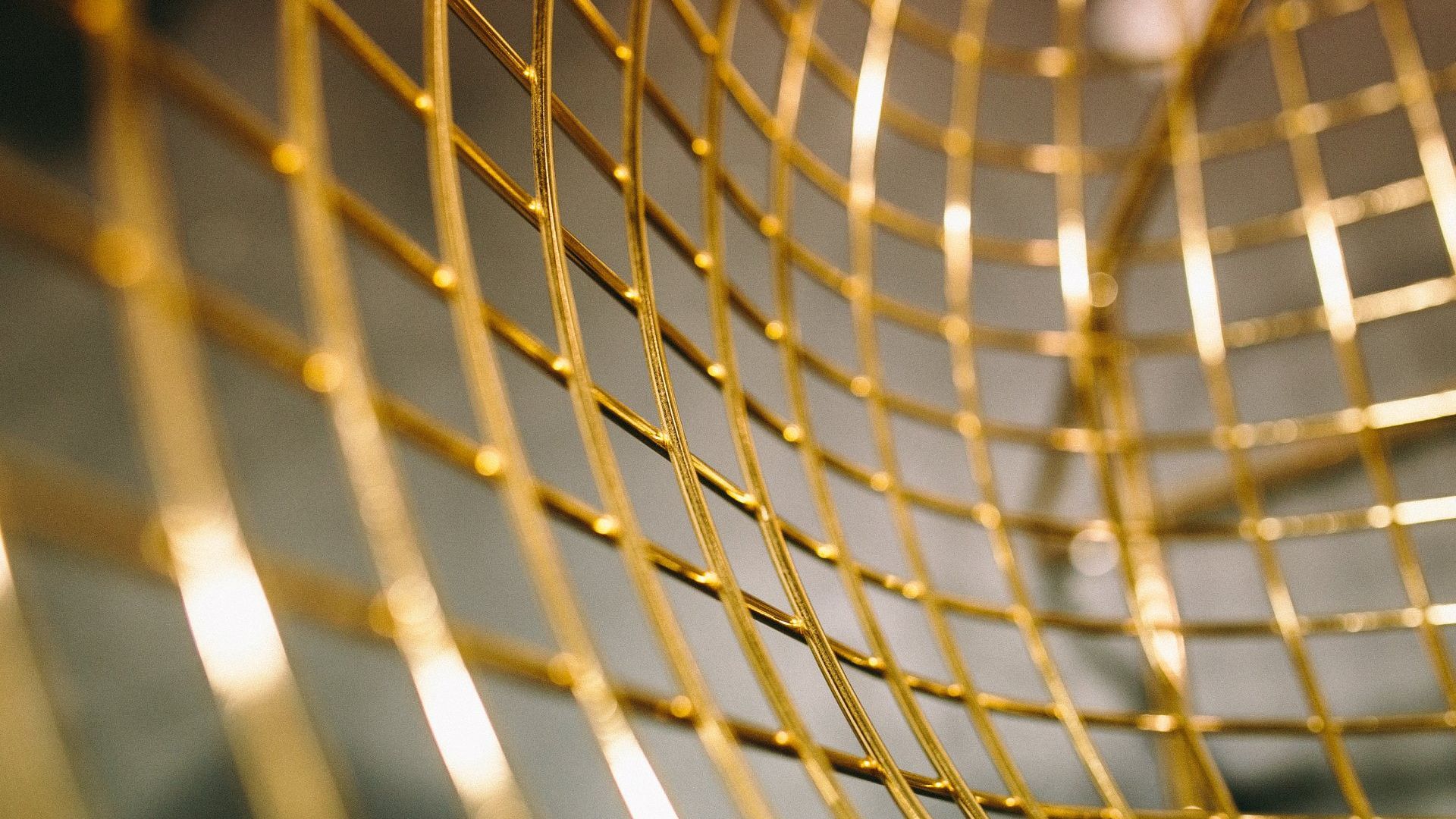 A close up of a gold wire sculpture on a table.