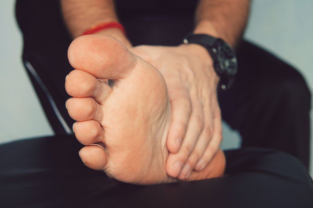 Man with painful and inflamed big toe needing a bunion specialist in Niagara Falls, NY