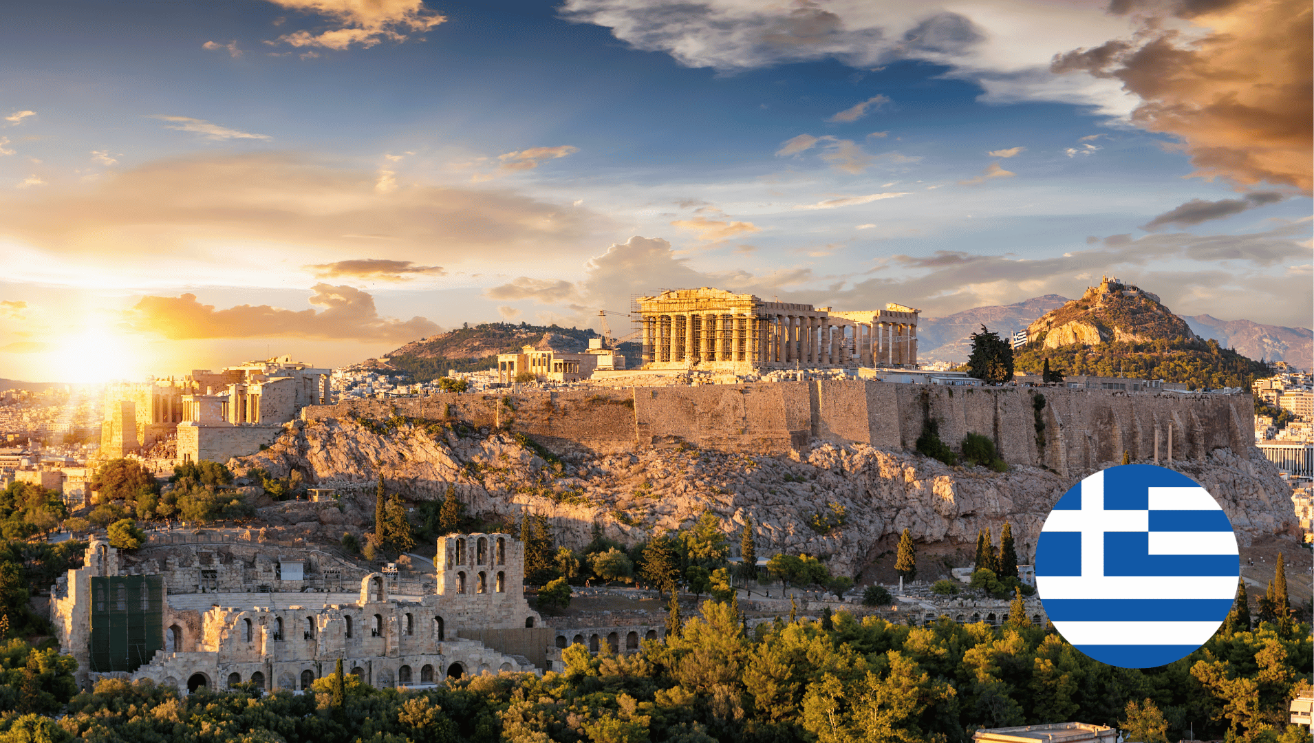 An aerial view of a city with a greek flag in the foreground.