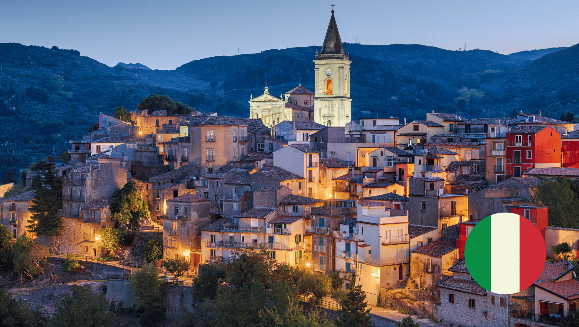 An aerial view of a small town in Sicily with a flag in the foreground