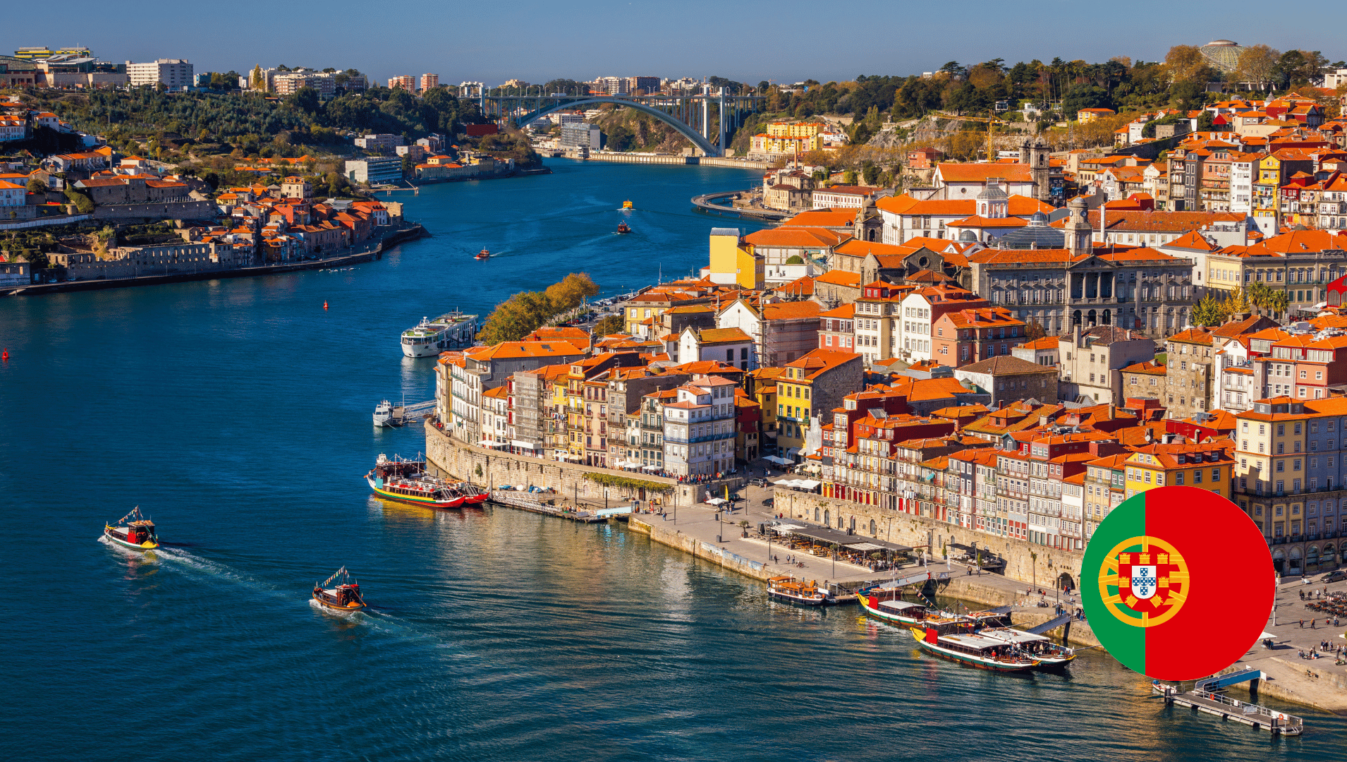 An aerial view of Lisbon next to Tagus River with Portugal flag in the foreground. 