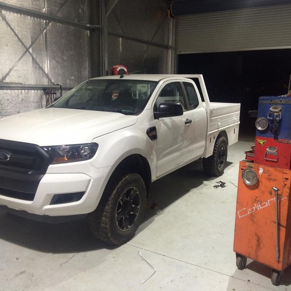 A White Ford Truck is Parked in a Garage — RK Diesel Services in Ciccone, NT