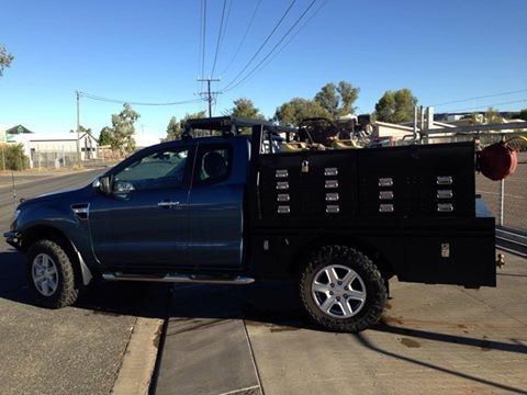 A Black Truck is Parked on the Side of the Road — RK Diesel Services in Ciccone, NT