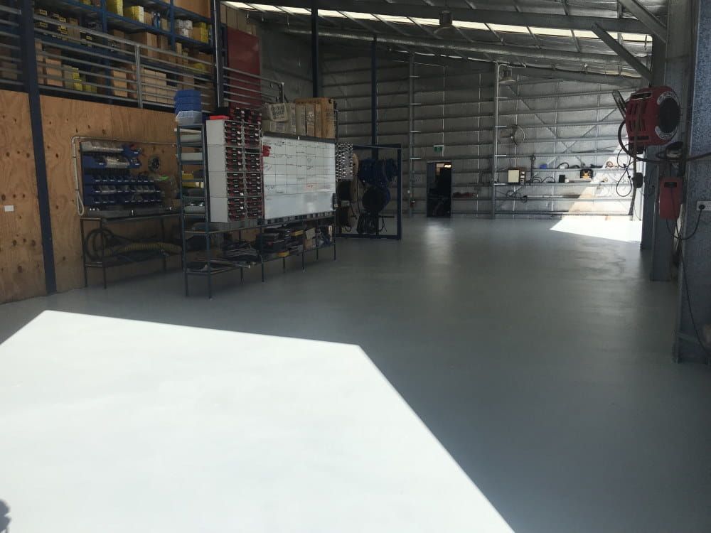A Large Warehouse With a White Board in the Middle of It — RK Diesel Services in Ciccone, NT