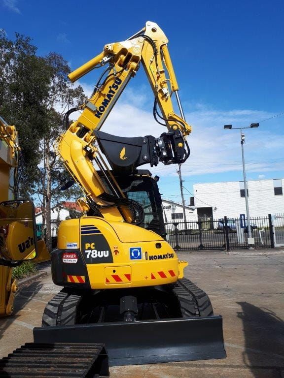 A Yellow Komatsu Excavator is Parked in a Parking Lot — RK Diesel Services in Ciccone, NT