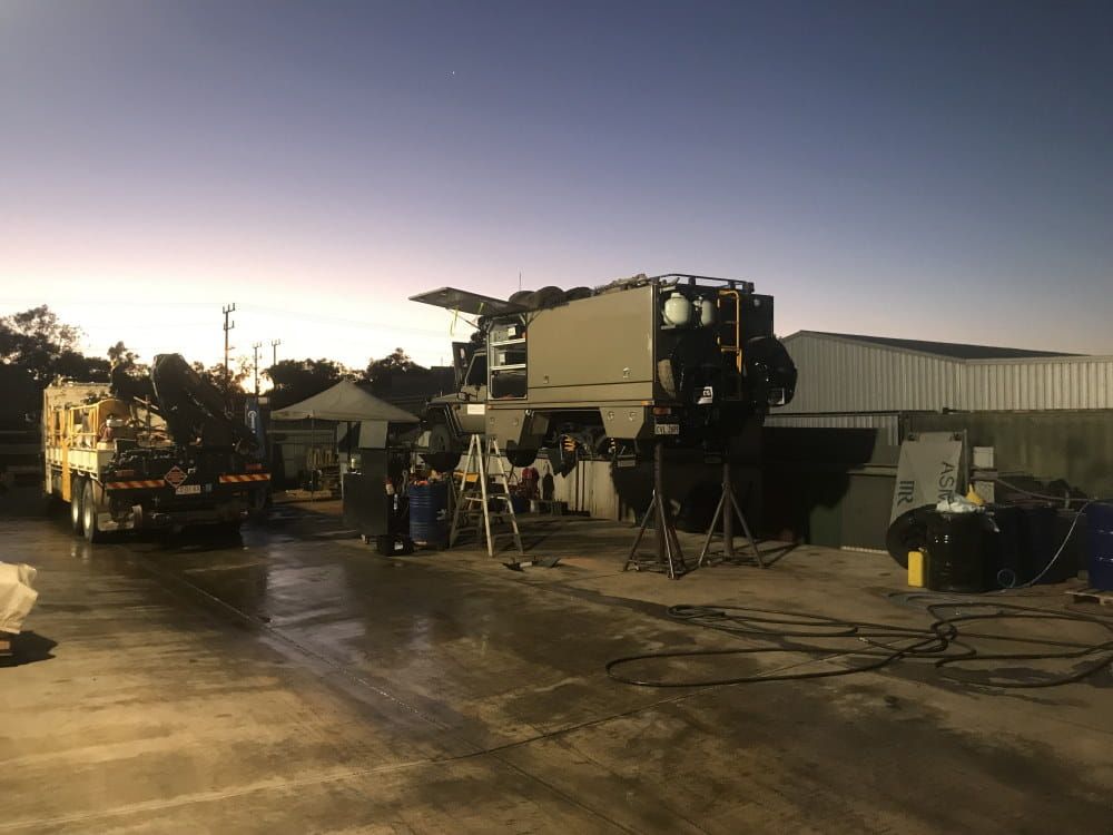 A Large Truck is Sitting in a Parking Lot Next to a Building — RK Diesel Services in Ciccone, NT
