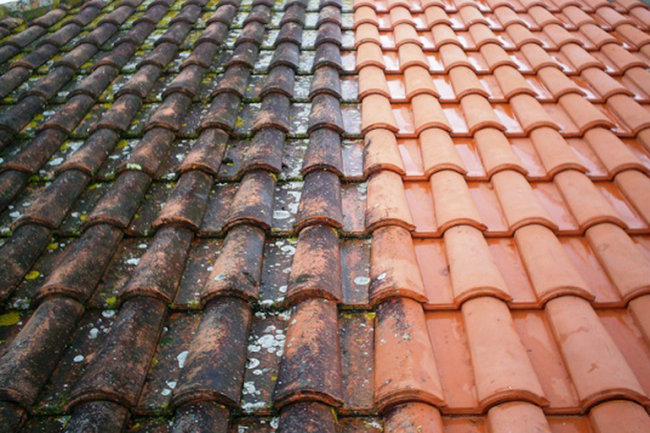 A before and after picture of a gutter on a roof. pressure washing roof cleaning services